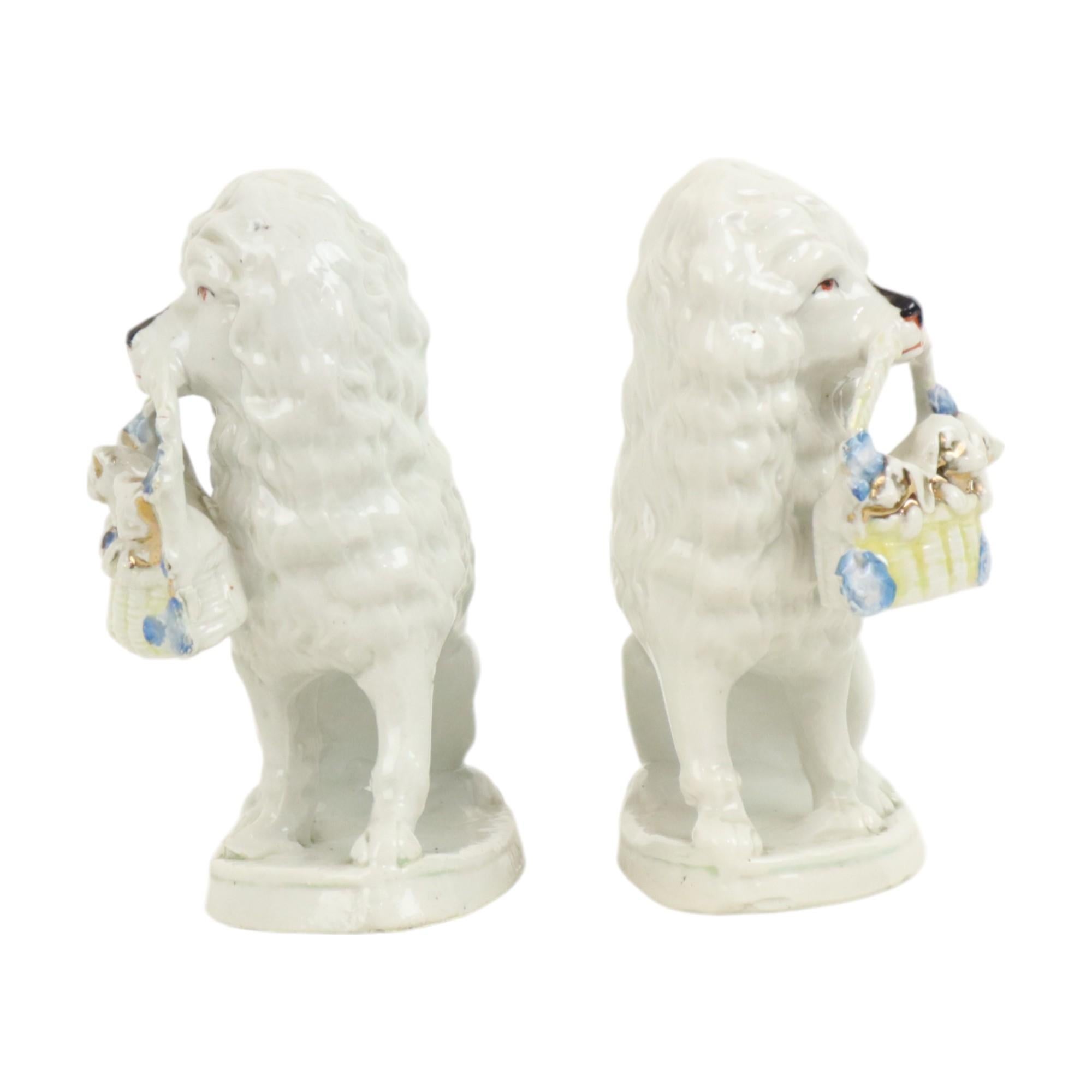 Rare antique pair of dog figurines made of hand-painted porcelain, so-called 'poodle dogs' or whore dogs, originating from the Jugendstil or Art Nouveau period, Germany, late 19th century.

The dogs have a large blue bow around their necks and each