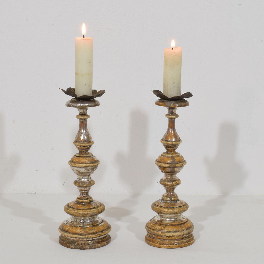 Great pair of wooden candleholders with their beautiful silver leaf gilding.
Italy, circa 1750-1800.
Weathered and old repair.

Measurements are individual.