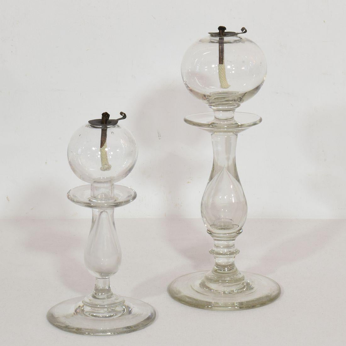 Rare collection of three hand blown glass weaver oil lamps from the South of France, France, circa 1800-1900
Very good condition. Copper wick holders of recent date.
Measures: H:14-25cm W:7-10,5cm D:7-10,5cm each.
Measurement here below is of the