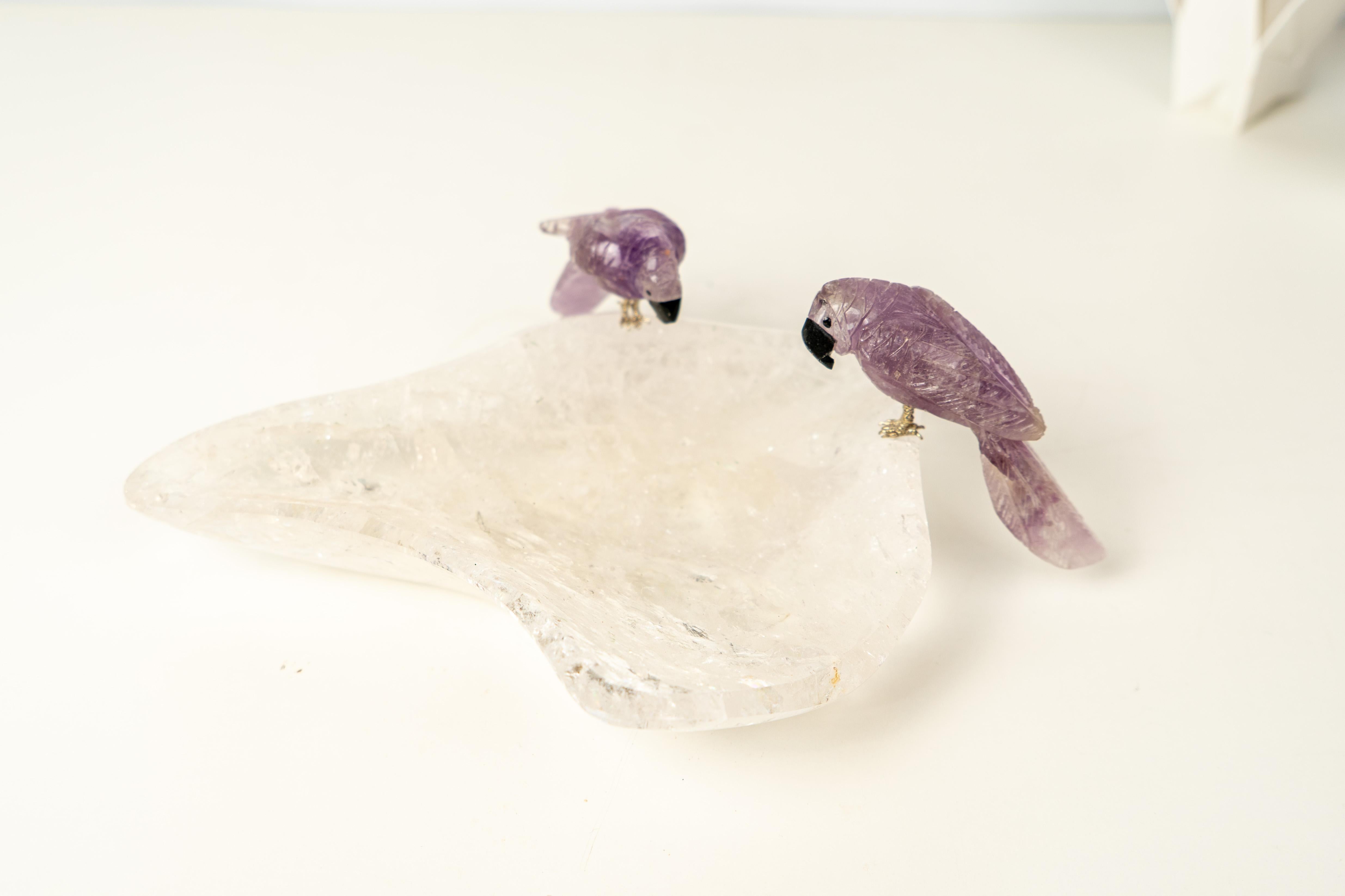 Delicate Pair of Parrots Sculpted in Amethyst, Set on a Clear Quartz Bowl

▫️ Description

Depicting a pair of Brazilian parrots, this hand-carved bowl draws inspiration from the country’s rich fauna and is crafted exclusively from the finest