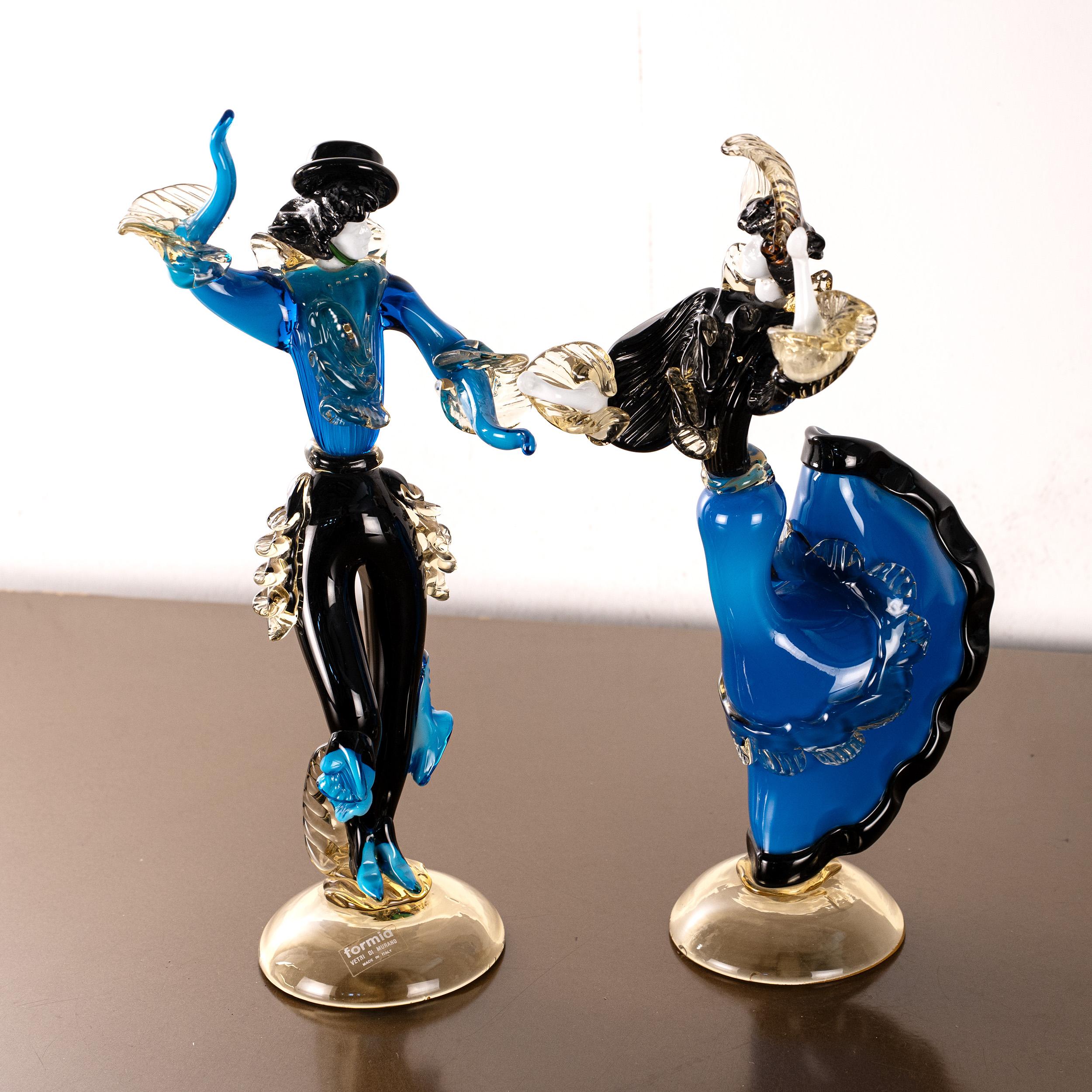 This captivating pair of Murano glass sculptures depicts a dancing couple frozen in motion—an ode to flamenco and gypsy tradition, interpreted through the mastery of Venetian glassmaking. Handcrafted in rich blue glass with elegant black and gold