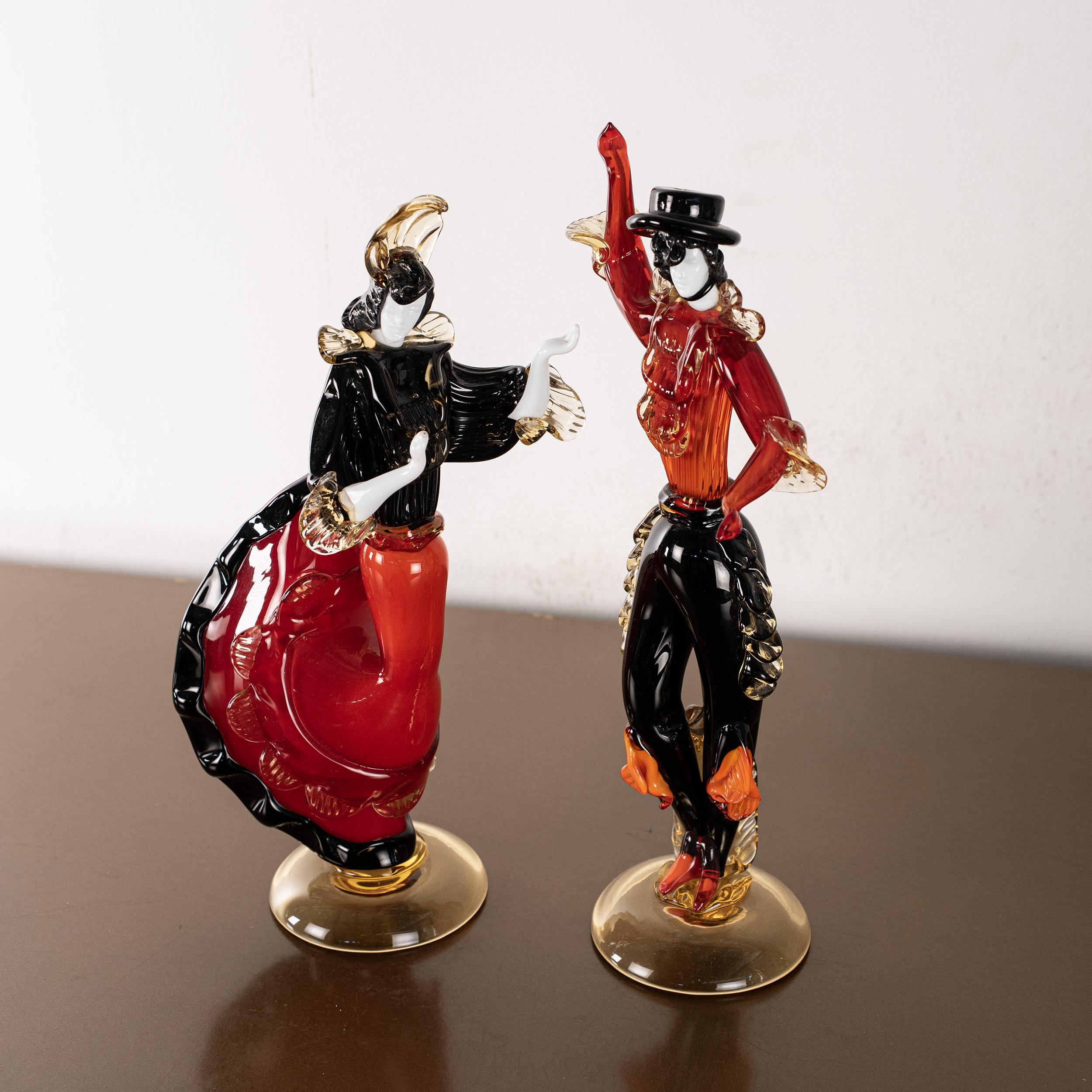 This captivating pair of Murano glass sculptures depicts a dancing couple frozen in motion—an ode to flamenco and gypsy tradition, interpreted through the mastery of Venetian glassmaking. Handcrafted in rich red glass with elegant black and gold