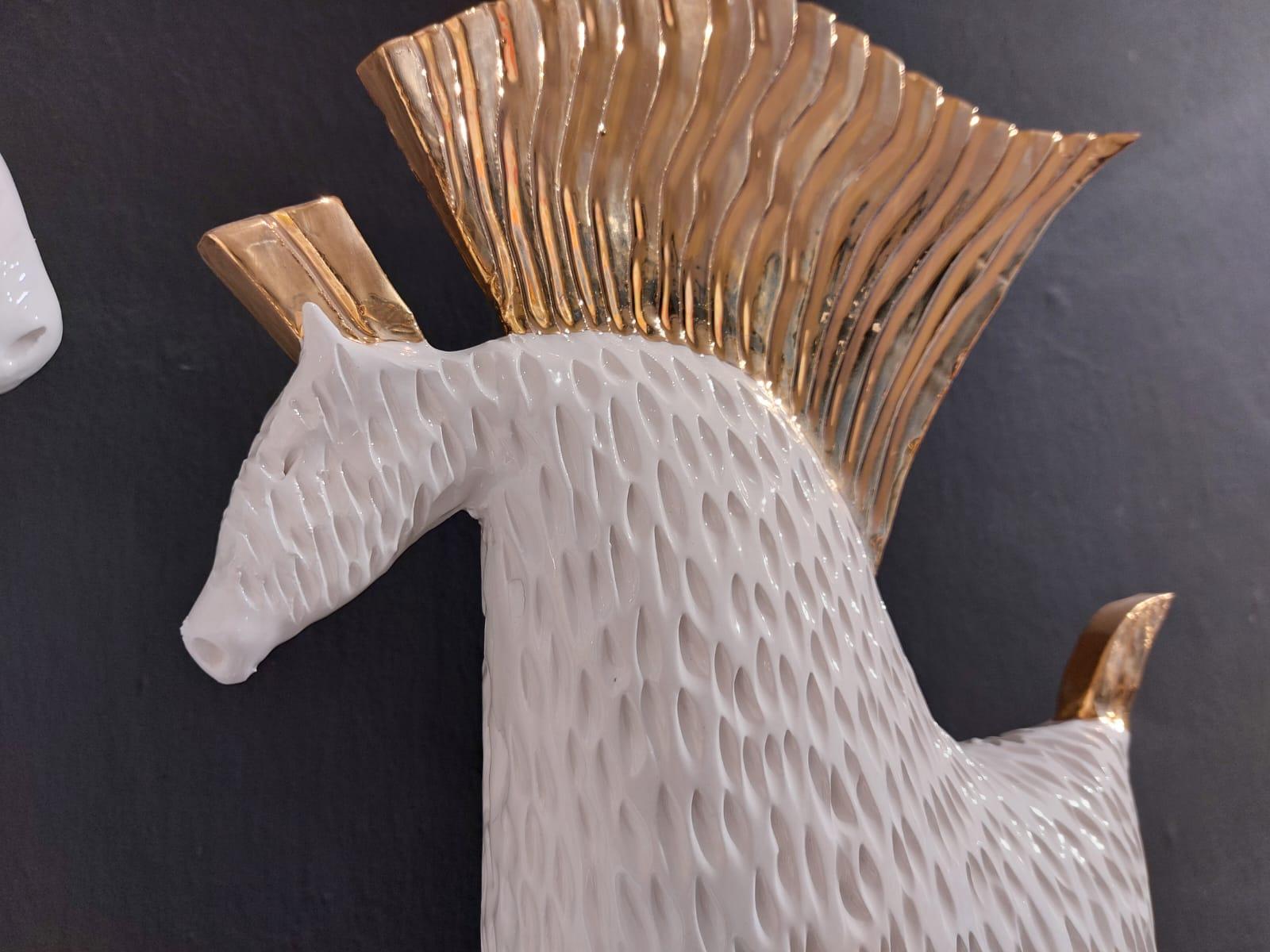 The piece is a unique representation of two horses in a modern way. The horses are gently finished with golden leaf.
Our designer creates these pieces completely by hand, without any mold. Any piece is different and created by the sapient hands of