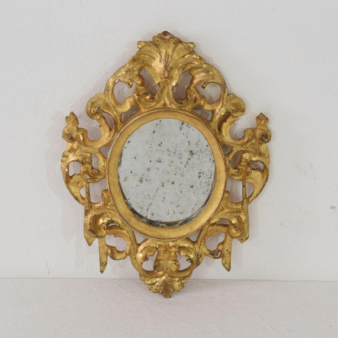 Unique and beautiful couple of miniature mirrors with its original gilding, Italy, circa 1750. Weathered.