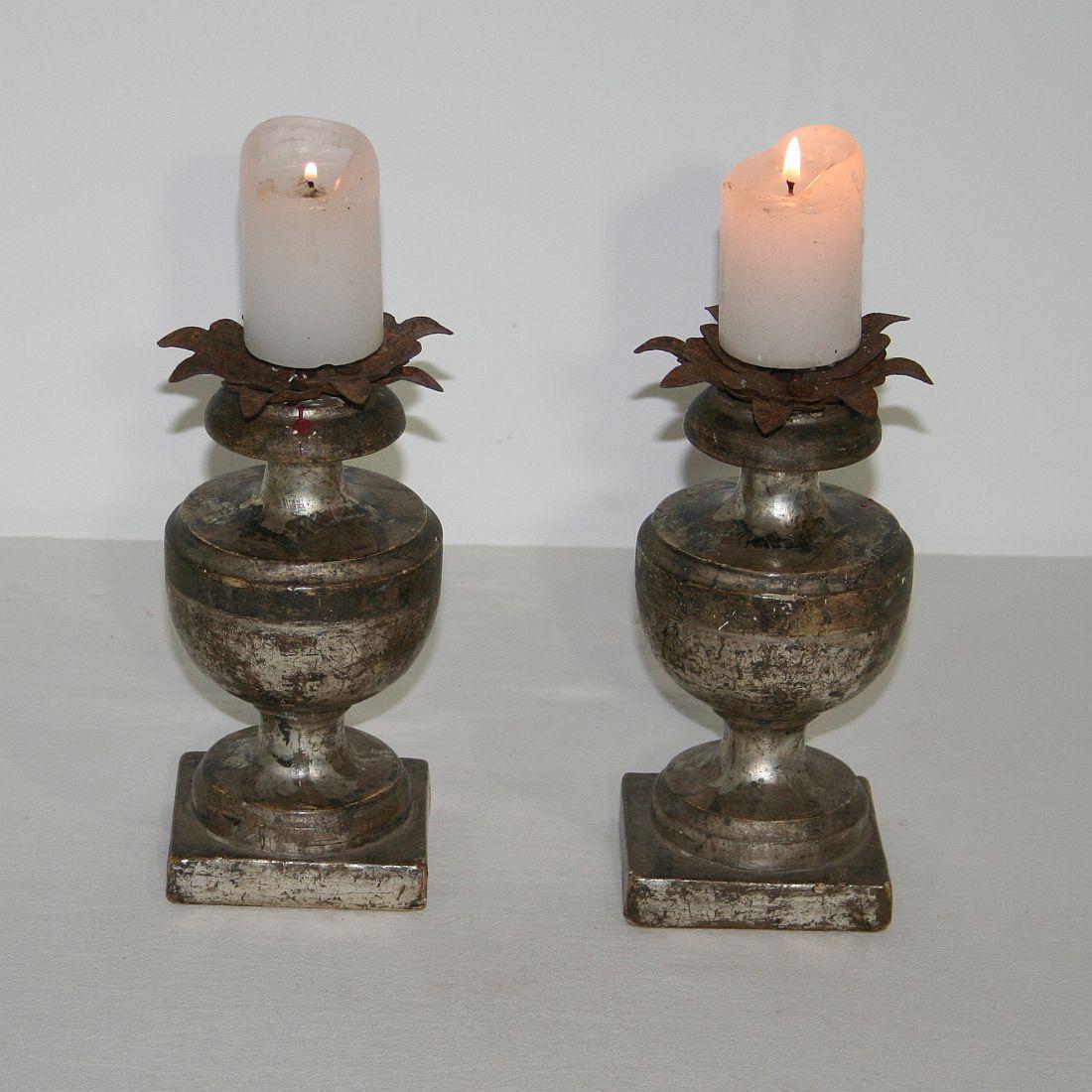 Great pair of small wooden candleholders with their original silver.
This type of candleholder you see more often gilded but in silver they are rare.
Italy, circa 1780-1800. 
Weathered.