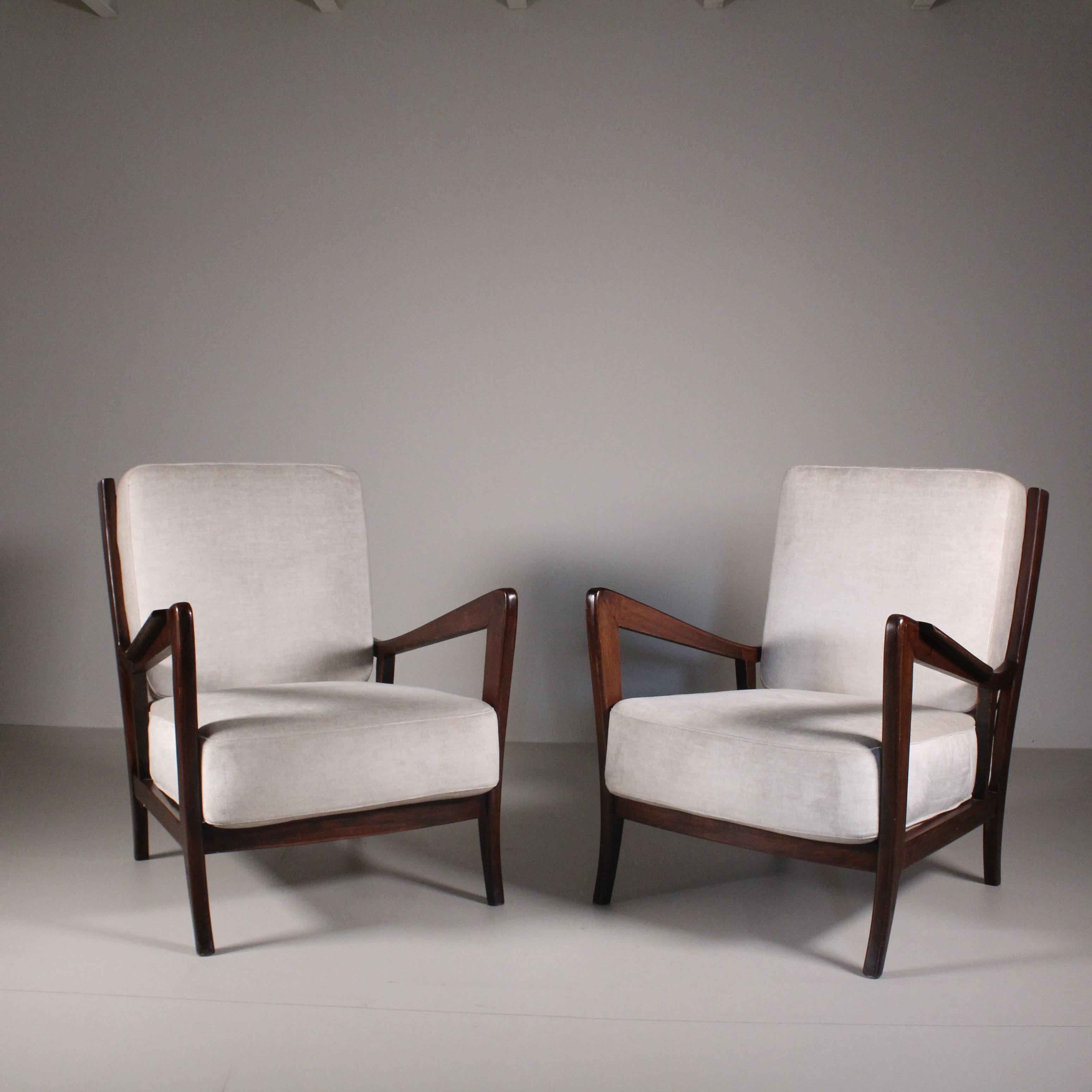 Pair of 1950s armchairs in a style clearly inspired by Gio Ponti, with a classic and typical mid-century style. The armchairs have been restored with. new upholstery and repainting of the wooden frame to bring them back to their original splendor.