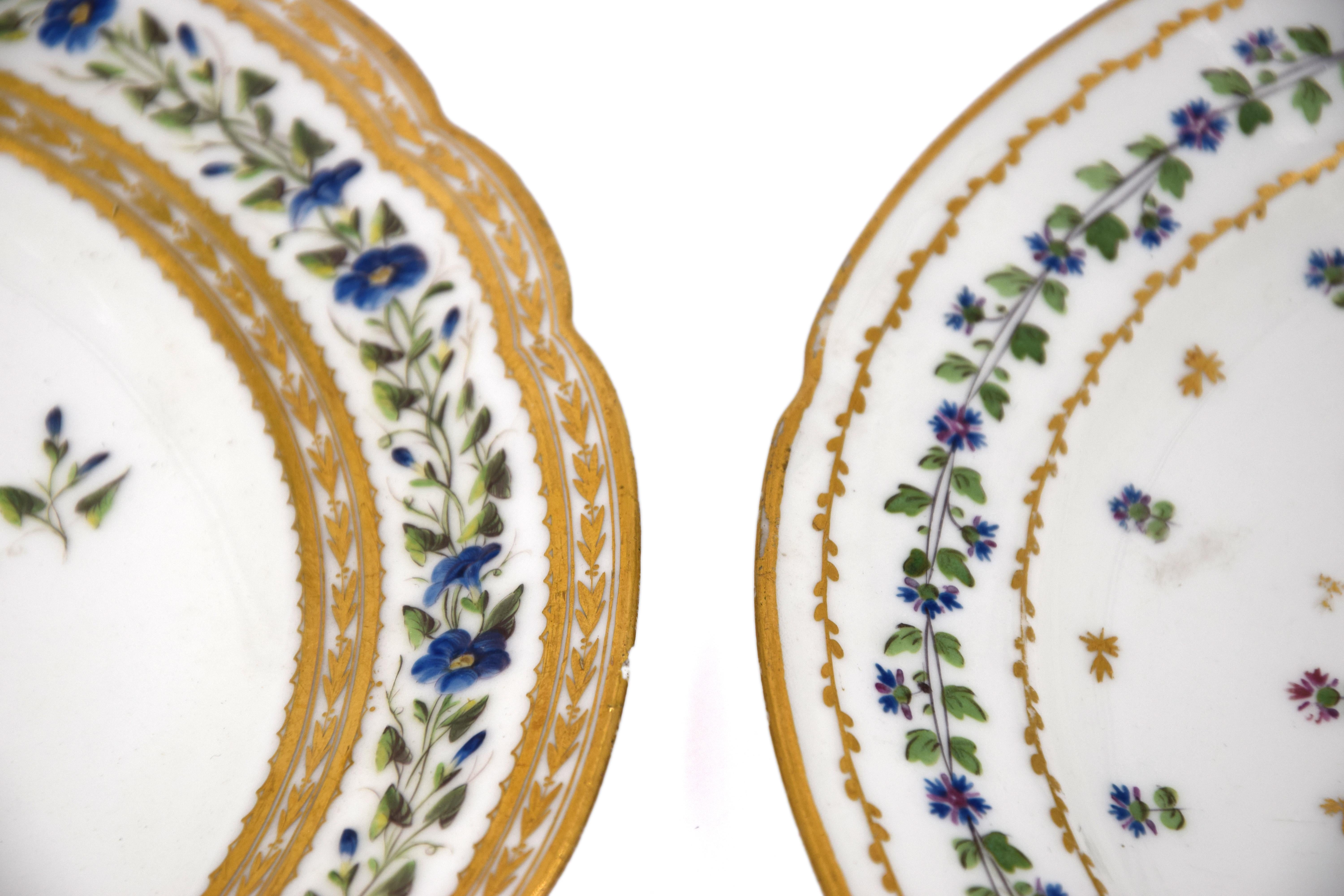 These Saxony Porcelain Plates are original decorative objects realized during the mid-XIX century, based on a eighteenth-century model. The two vintage plates are finely decorated with floral motifs and gilded decorations.

On one of the two plates,