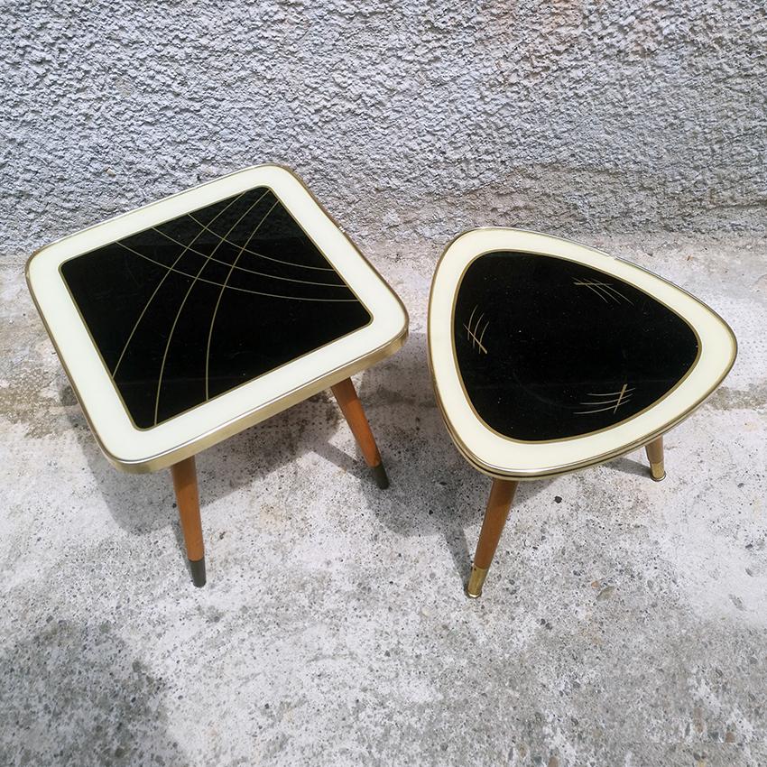 Couple of small coffee tables from Denmark, 1960s
Two small coffee tables from 1960s, coming from north Europe, of two different forms. One is squared and the second is triangular, both with rounded angles and a glass on the top, an extremely