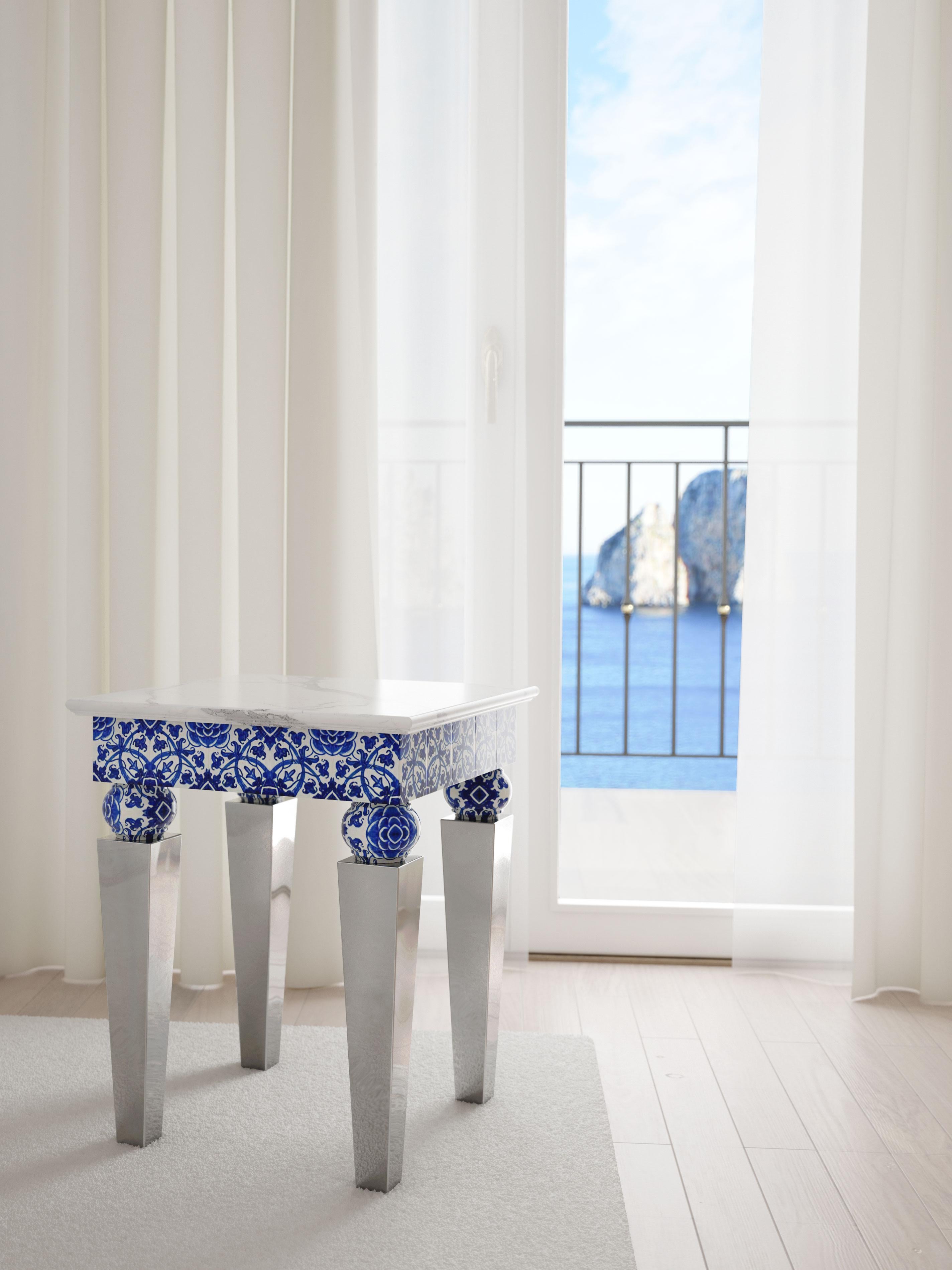 Exclusive pair of side tables with white Statuary marble top, mirror finish steel legs and embellished with 20 blue and white glazed ceramic tiles. The majolica elements are hand crafted and hand painted in Italy.
This tables called 