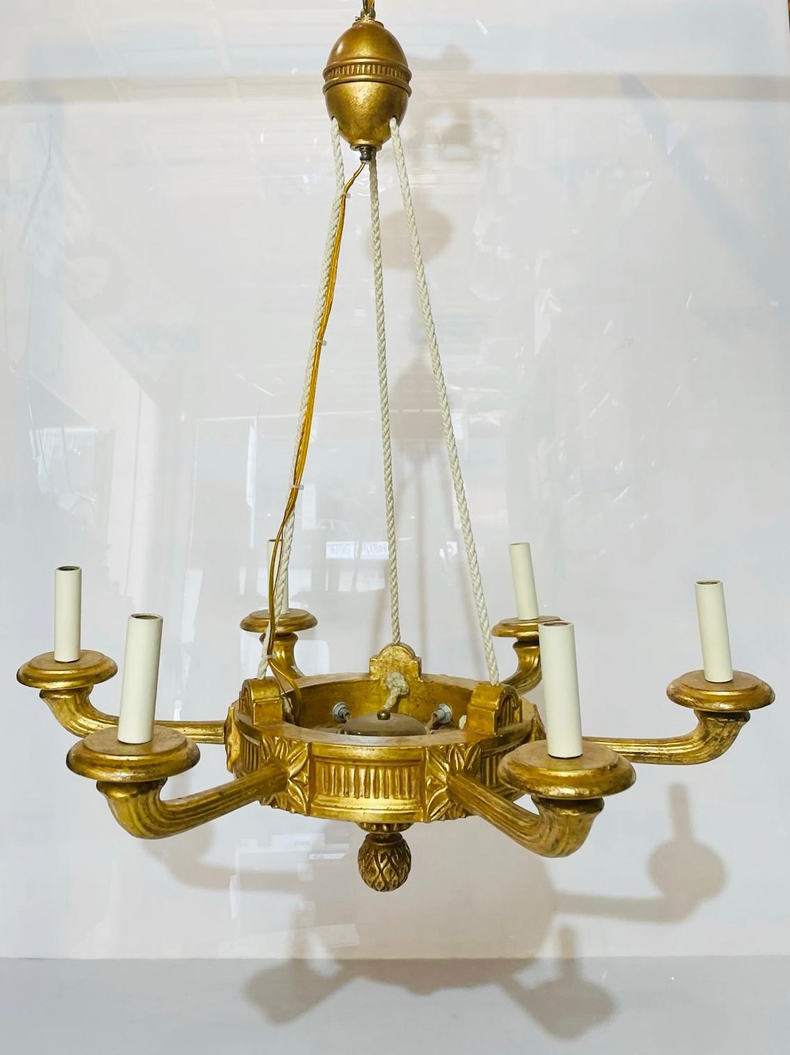 Based on an original Louis XVI antique we discovered in France, this chandelier has a neo-classical aesthetic. Decorative details, like the rope effect on the arms and patterned finial, are intricately hand-carved in giltwood.

Craftsmen