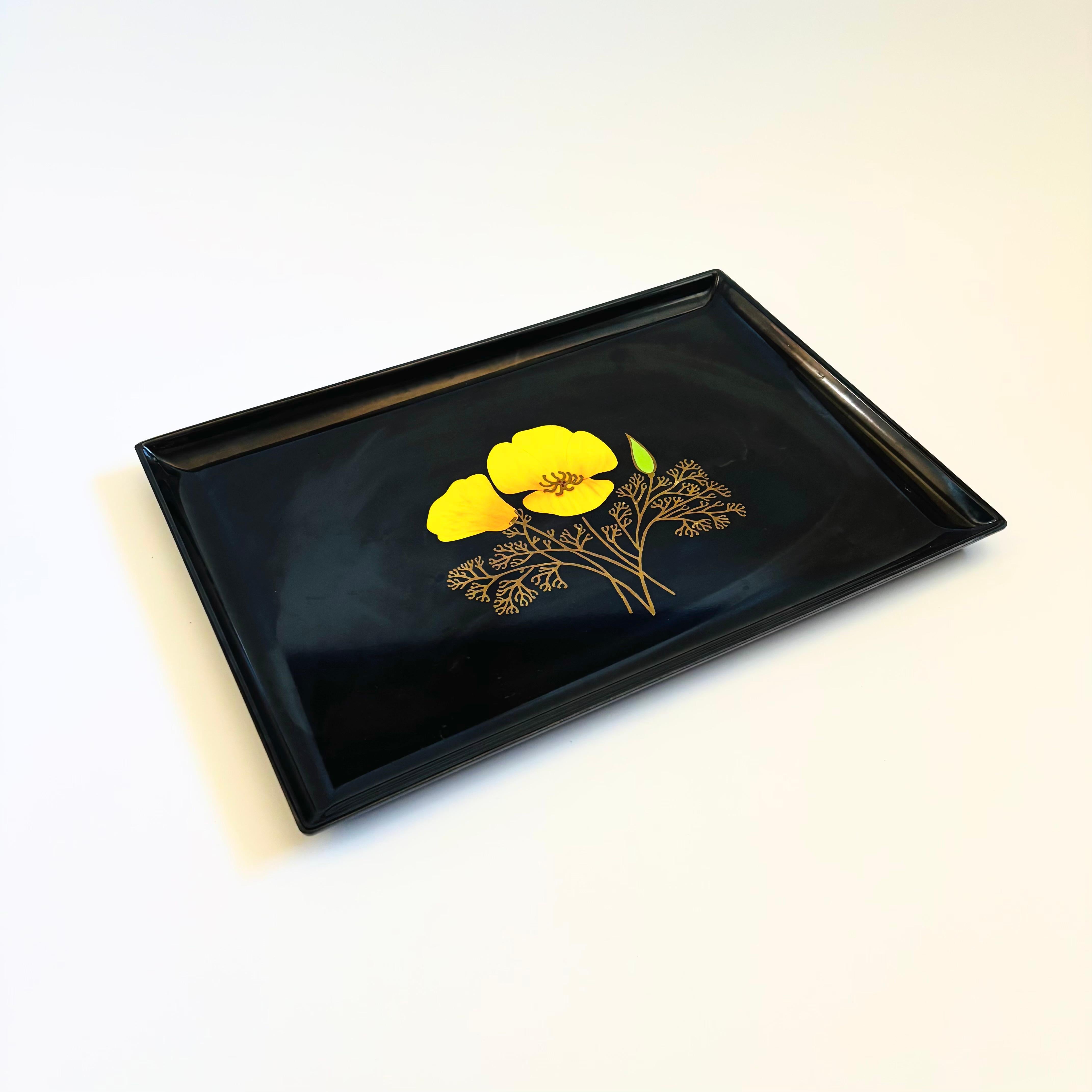 A large vintage rectangular resin tray. Decorated in the center with a California poppy outlined in brass. Made by Couroc, original stickers are on the back.

