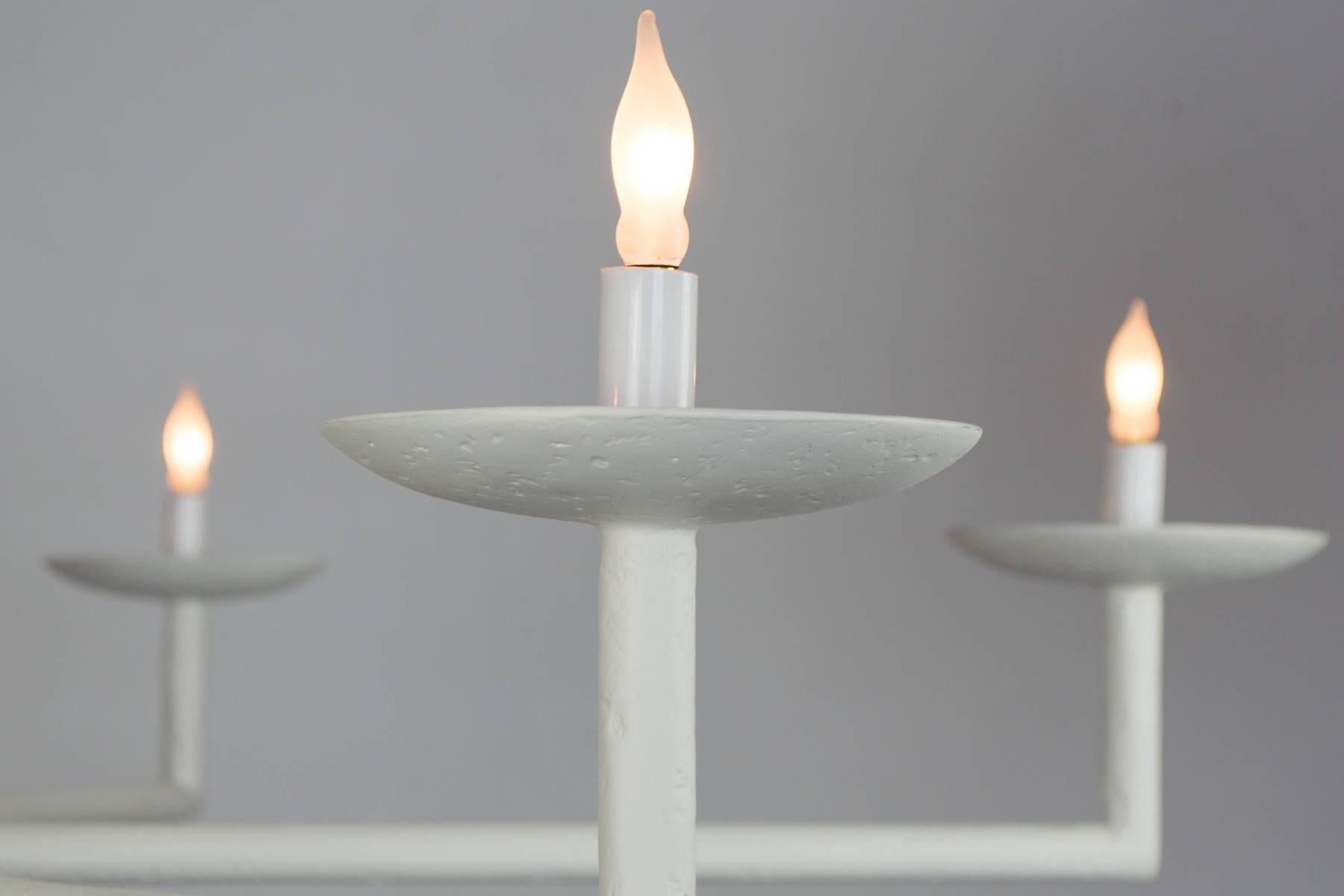 Questo popolare lampadario si adatta a tutti gli schemi di arredamento, dal moderno al tradizionale. Si tratta di una rivisitazione del classico design dei portacandele. Fornisce una luce sufficiente per essere il fulcro di una sala da pranzo o di