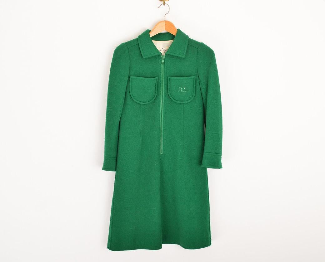 Swinging sixties, 1960's Andrè Courrèges mod-style, zip down mini dress in emerald green wool. 
 
Features;
Central line zip fasten
x2 Breast pockets
Iconic Vinyl Courrèges logo on left breast pocket
Long sleeves
Fully lined interior
33% Wool, 27%
