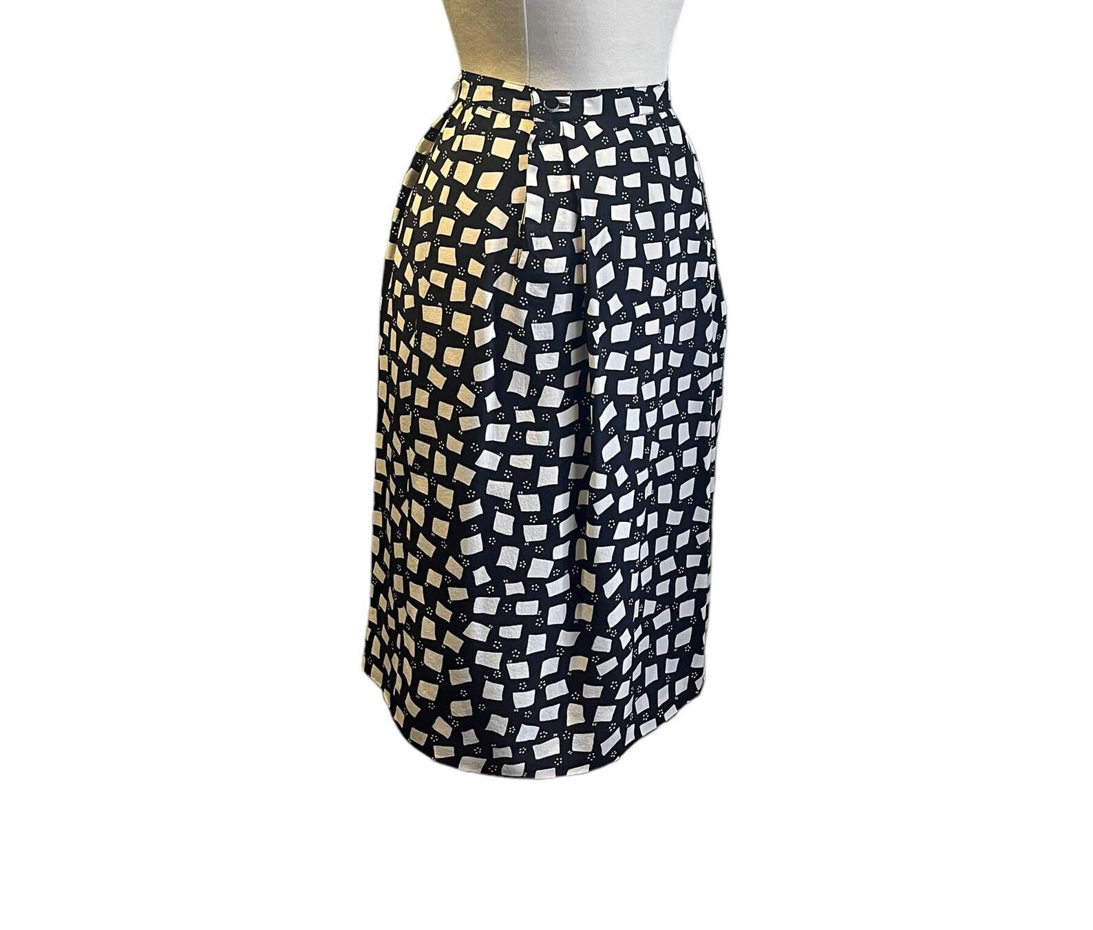 Vintage Courrèges black and ivory silk skirt. Abstract squares and rectangles with tiny dots and small logo print. High waist. Hidden metal zipper with two buttons at waist. Has pockets. Skirt is lined. Dry cleaned.

Circa 1970s
Courrèges
Made in