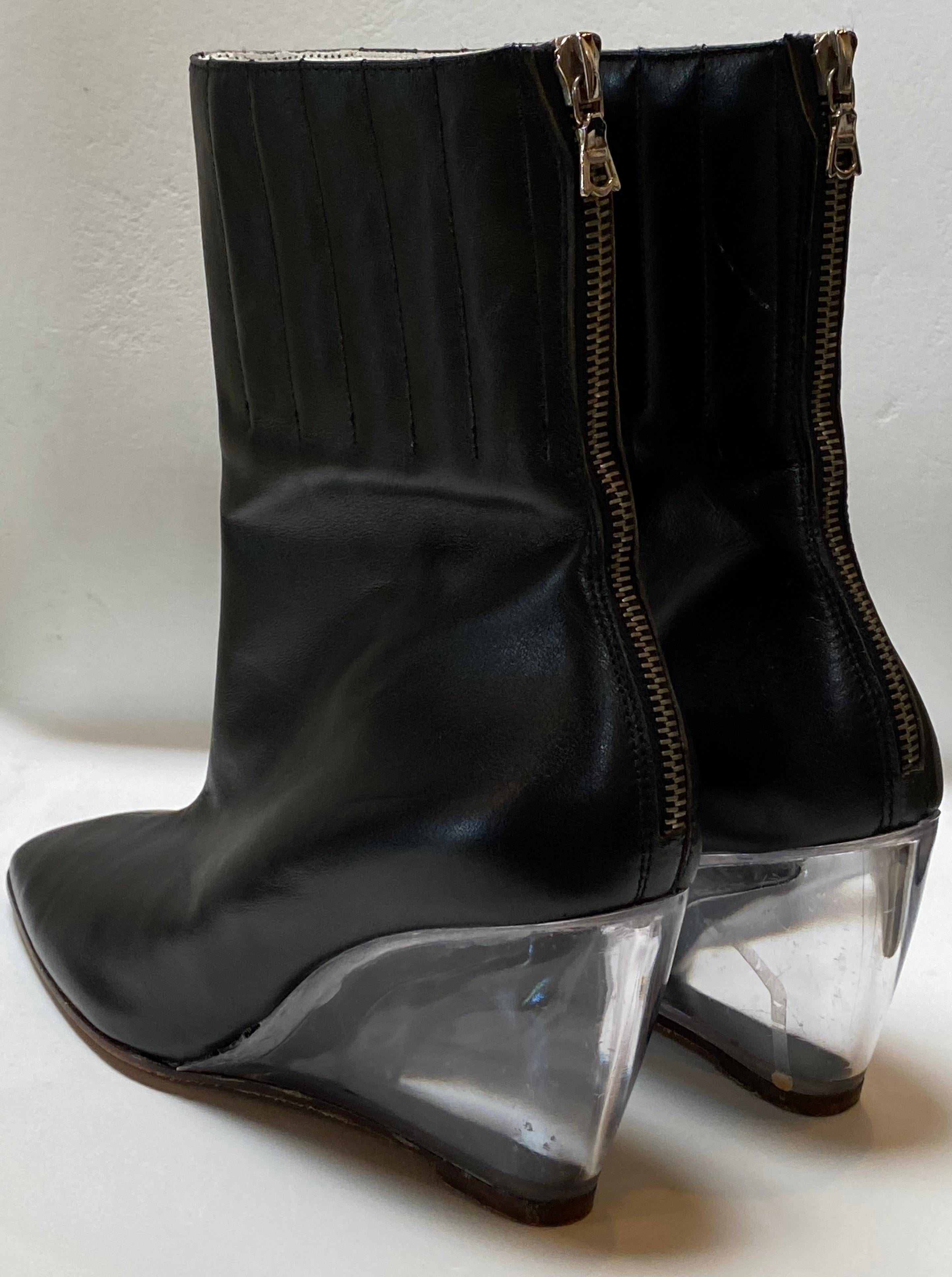 Vintage Courreges black leather ankle boot features special plexiglass wedge heel. Sturdy back zipper.