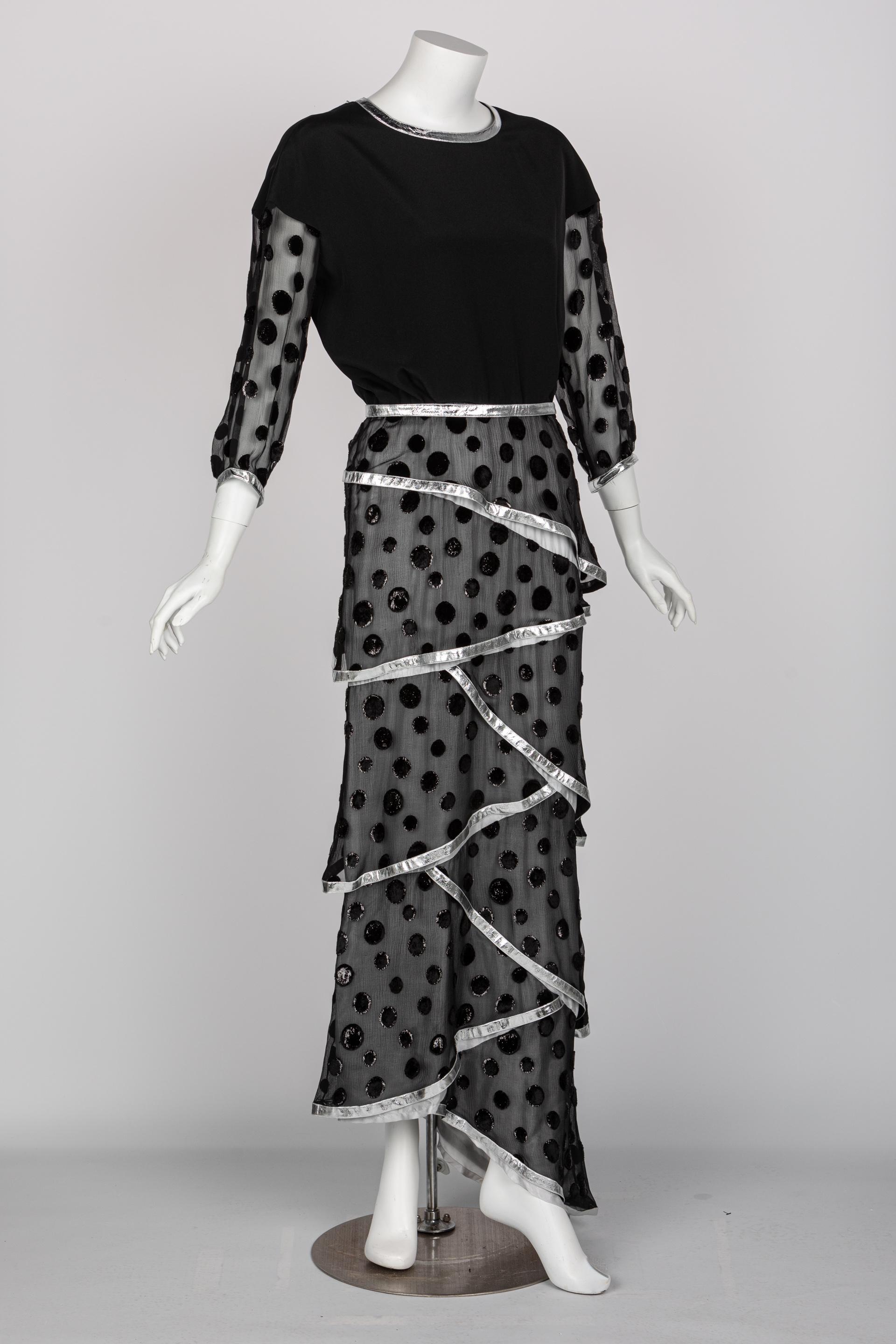 André Courrèges was a visionary of youthful and innovative designs. While known for his quirky space-age fashions, his later work offered a blend between unconventional fabrics and classic design features. This 1973 maxi dress features a silky black