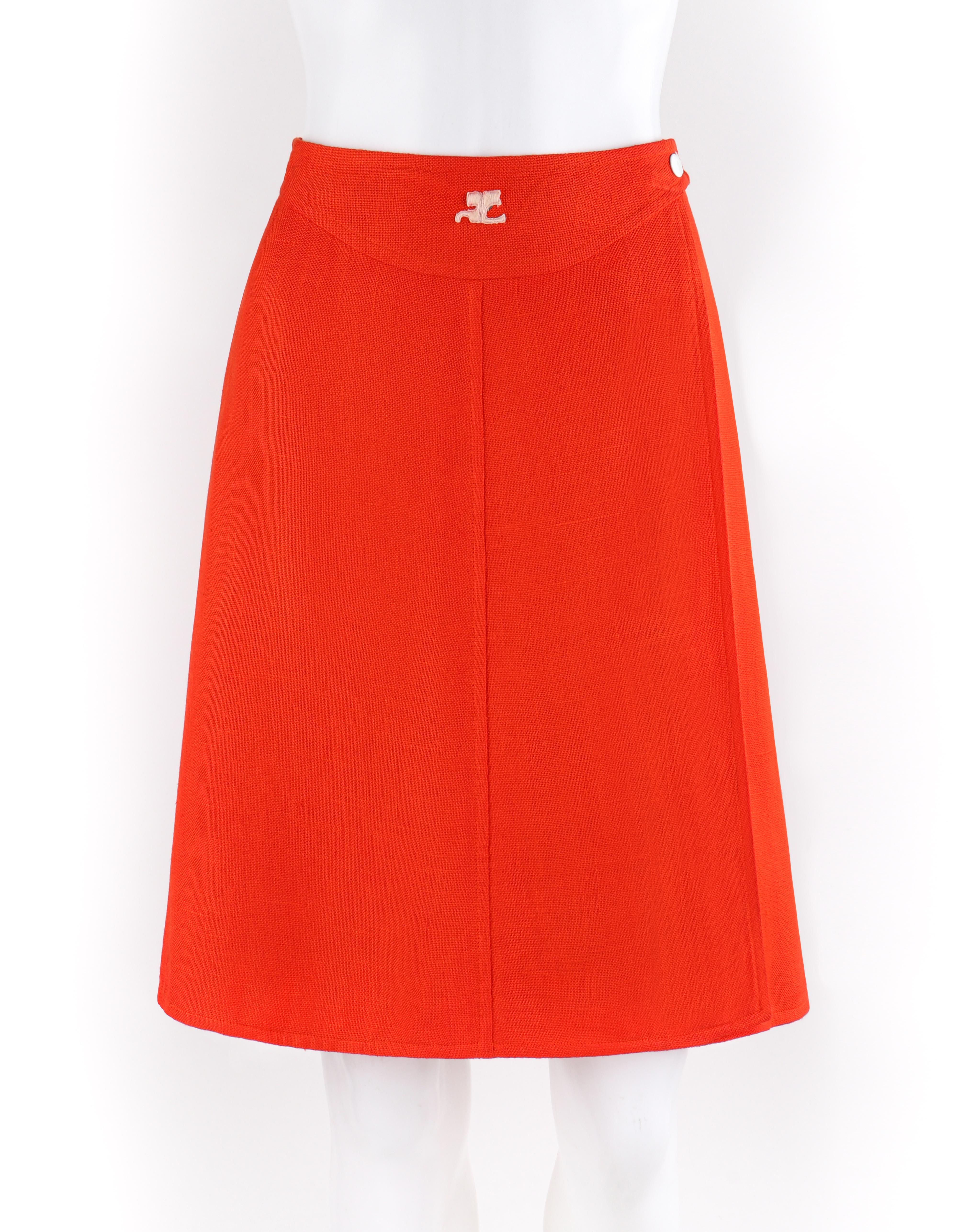 COURREGES c.1960’s Orange White Signature Logo Snap Button Up A-Line Wrap Skirt
Circa: 1960’s
Label(s): Courreges Paris
Designer: Andre Courreges
Style: A-line wrap skirt
Color(s): Orange, white
Lined: Yes
Marked Fabric Content: Shell: “100%