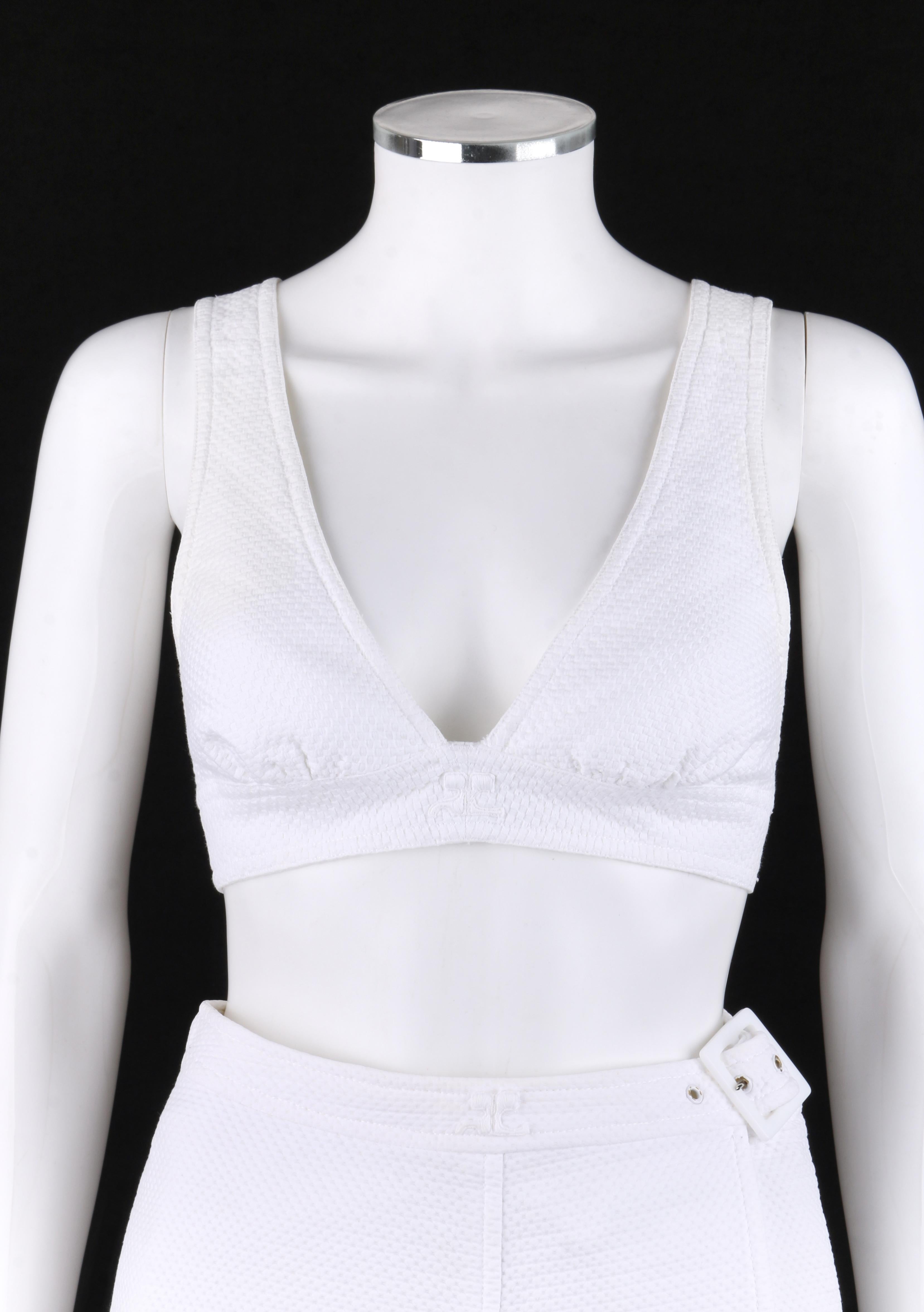 COURREGES c.1970’s 2 Pc White Textured Bralette Tank Top Belted Wrap Skirt Set
 
Circa: 1970’s
Label(s): Courreges Paris / Made in France  
Style: Bralette top and wrap skirt.
Color(s): White 
Lined: No
Marked Fabric Content: 100% Cotton
Additional