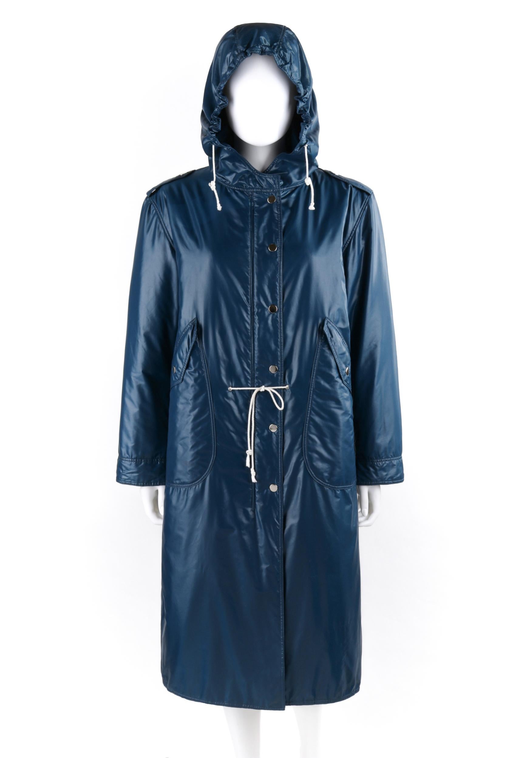 COURREGES c.1970's Hyperbole Navy Blue Drawstring Windbreaker Parka Raincoat 

Circa: 1970’s
Label(s): Courreges Hyperbole
Designer: Andre Courreges
Style: Full-length raincoat
Color(s): Shades of blue, white, and silver
Lined: Yes
Marked Fabric