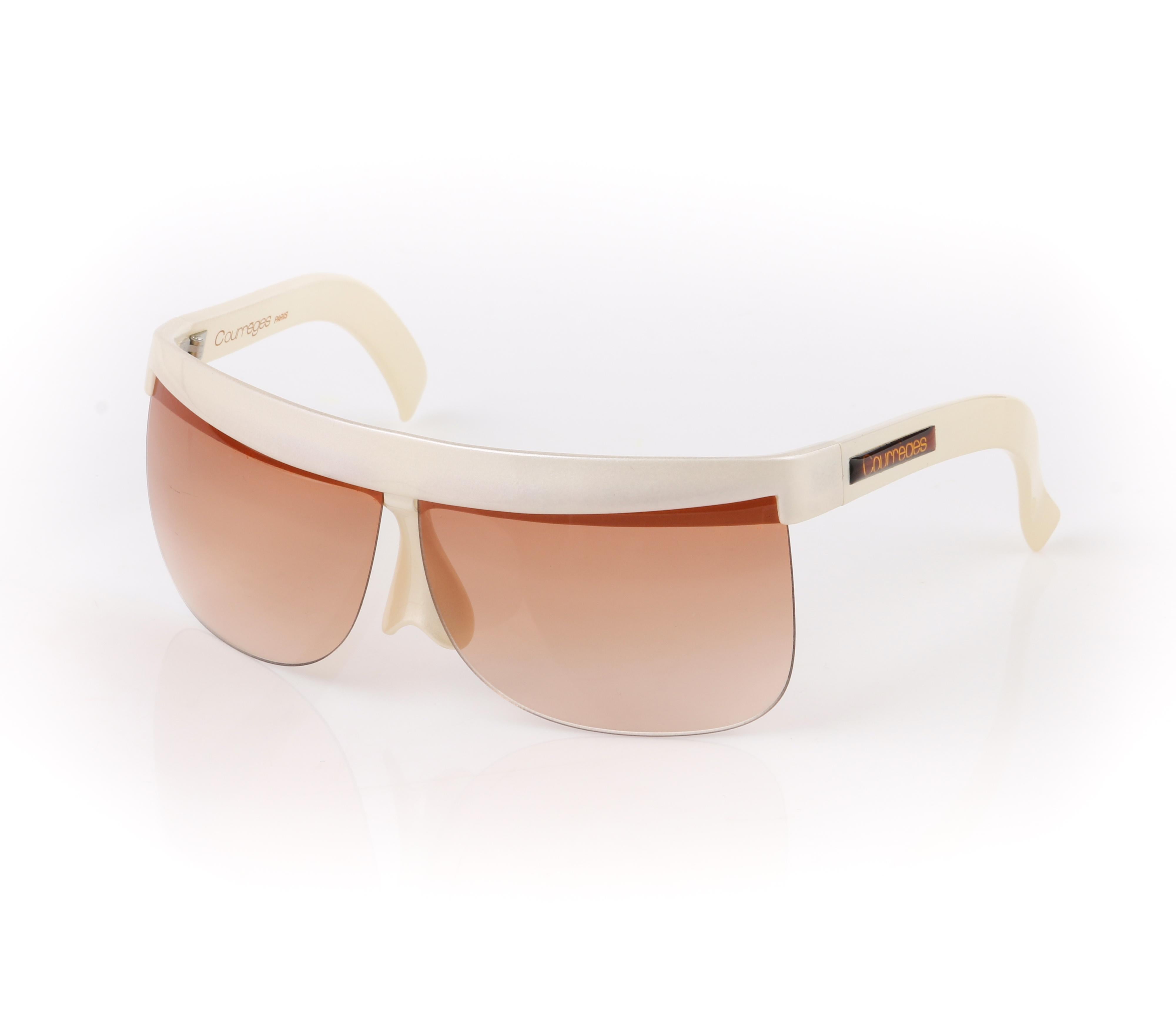 DESCRIPTION: COURREGES c.1970's Off White Plastic Half Frame Futuristic Sunglasses 7853
 
Circa: c.1970’s
Designer: Andre Courreges
Style: Half frame sunglasses
Color(s): Shades of off white and tan
Unmarked Material (feel of): Plastic
Additional