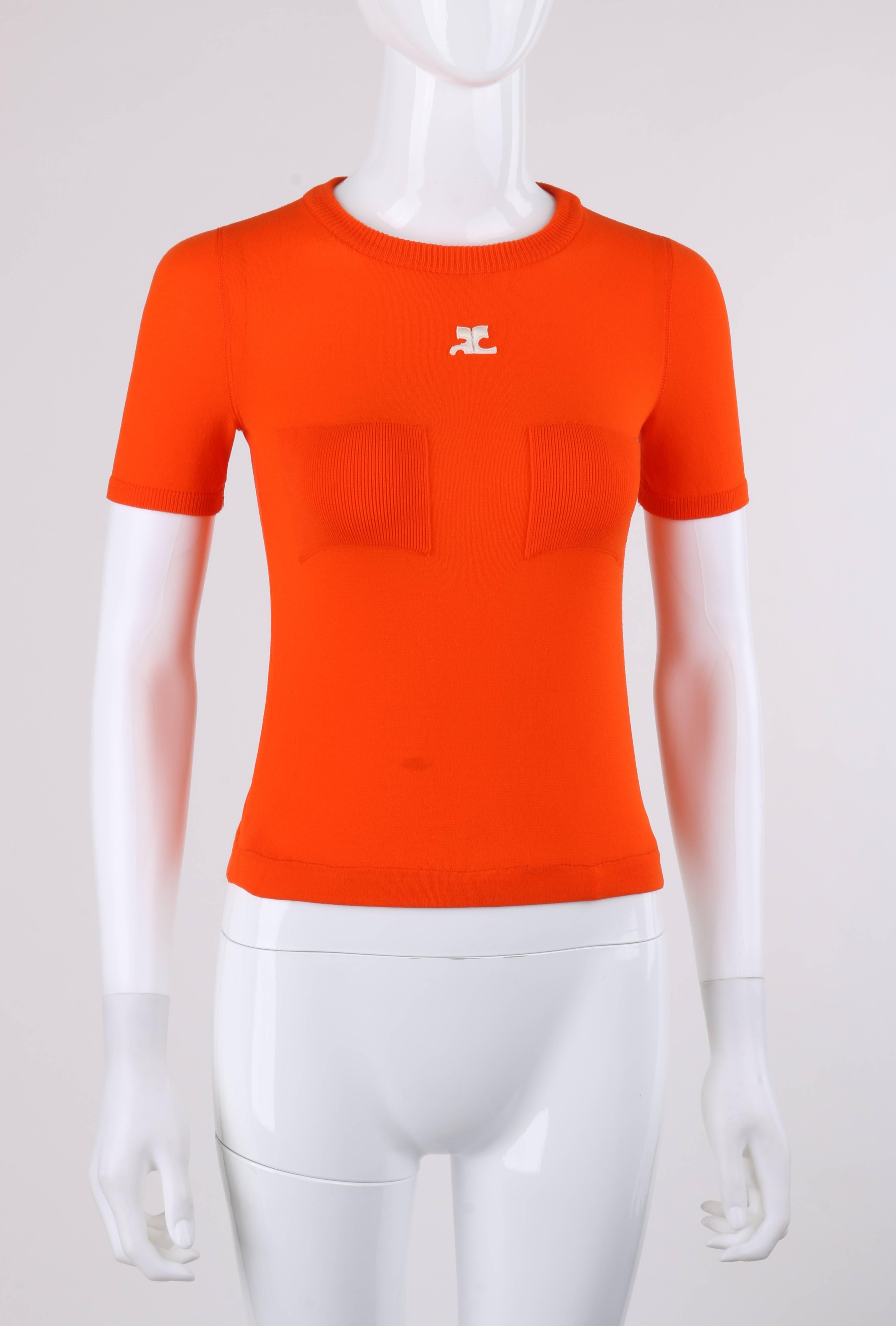 Vintage Courreges c.1970's orange knit short sleeve crewneck top. Designed by Andre Courreges. Rib knit crew neckline Short sleeves with rib knit detail at cuffs. Two front square knit patches. Center front white 