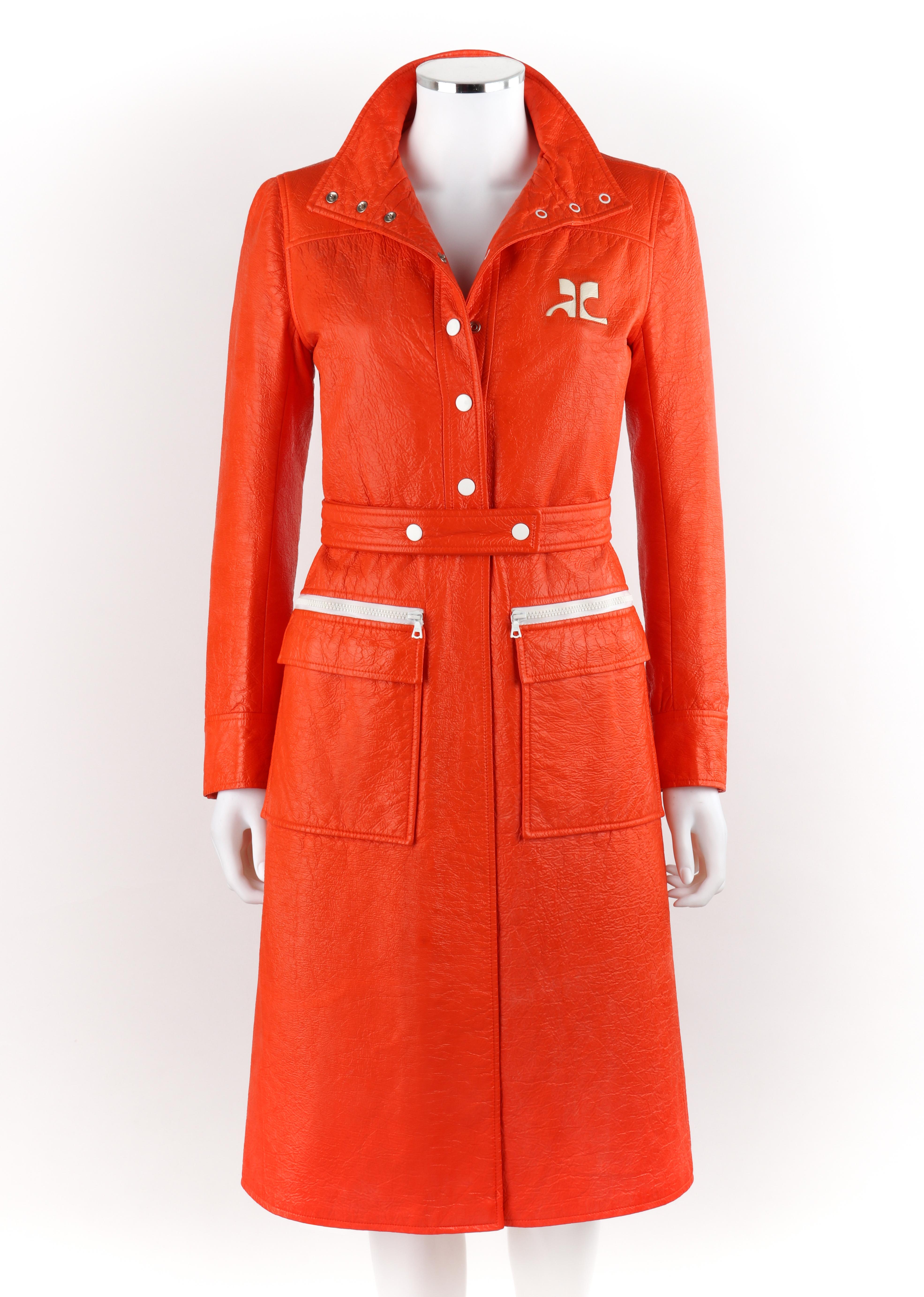 COURREGES c.1972 Orange Textured Vinyl Mod Signature Logo Trench Coat Jacket 
 
Circa: 1970’s
Label(s): Courreges Paris 
Style: Trench Coat
Color(s): Orange & White
Lined: Yes
Marked Fabric Content: Exterior: 85% Cotton; 15% Spandex. Lining: 100%