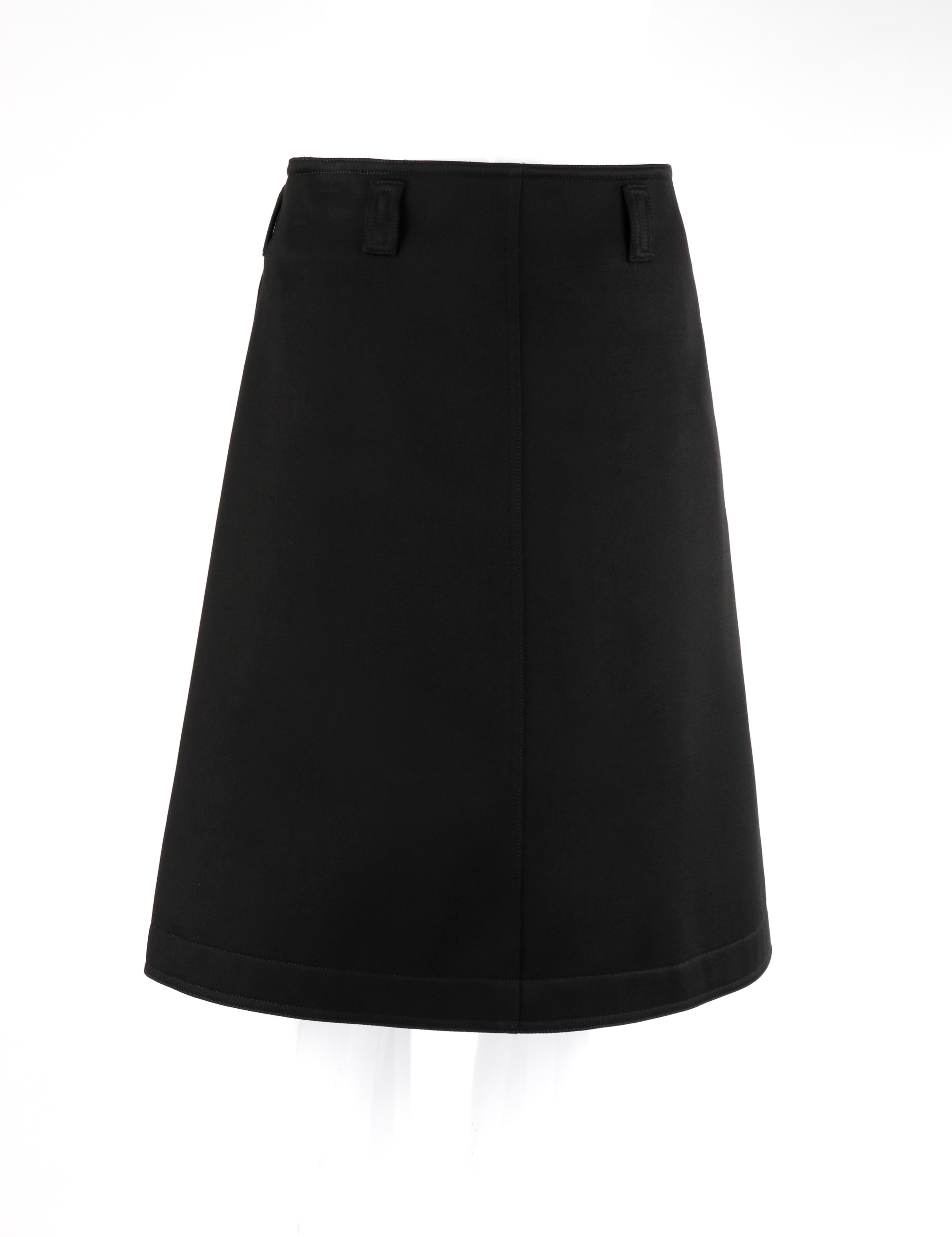 COURREGES c.1990's Black Classic Below Knee Length A-Line Skirt

Circa: 1990's
Brand / Manufacturer: Courreges
Designer: Andre Courreges
Style: A-line skirt
Color(s): Black (exterior, interior)
Lined: No
Marked Fabric Content: “100% cotton”
Unmarked