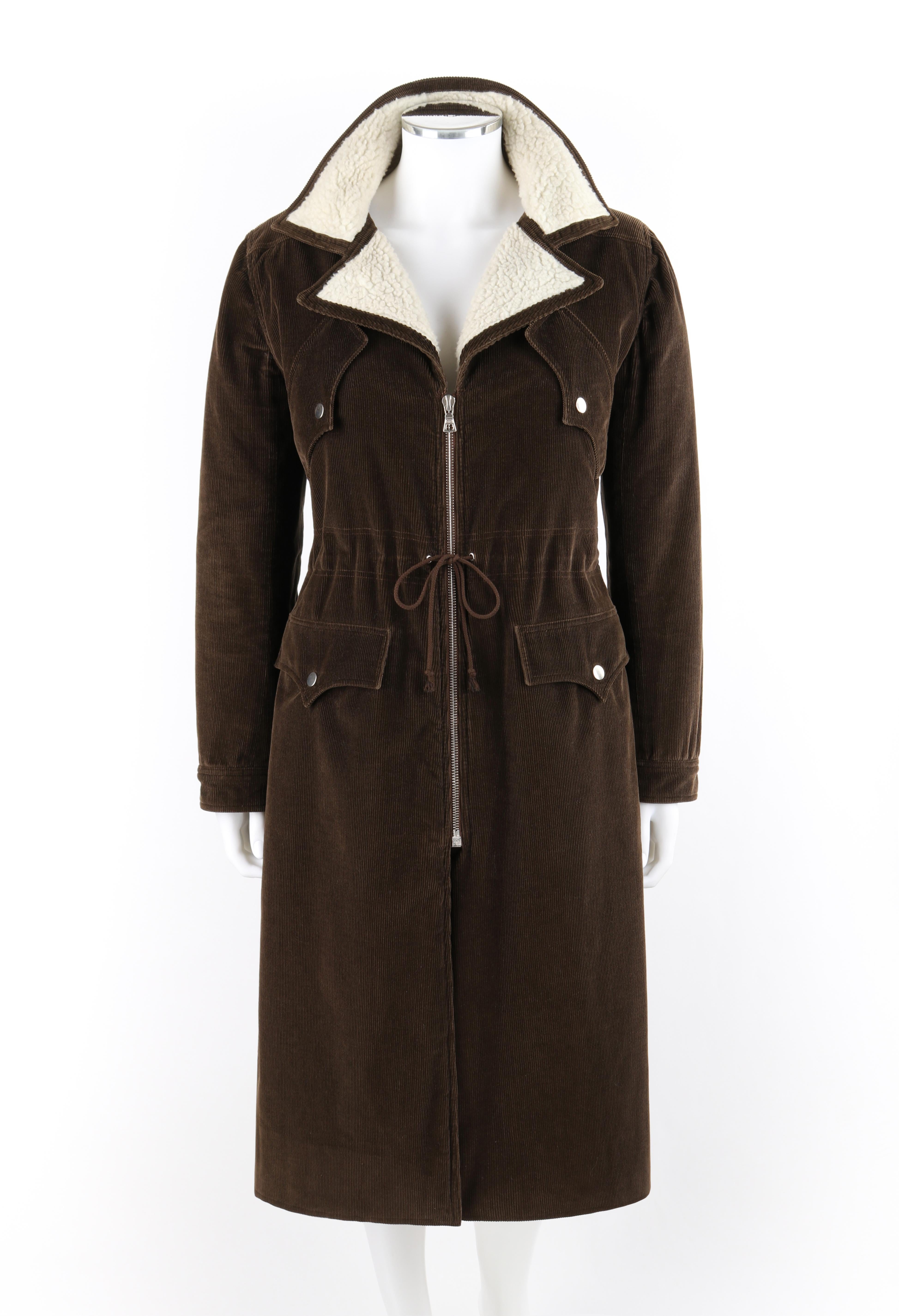 COURREGES Couture Future c.1970’s Brown Corduroy Cinched Waist Long Coat Jacket

Circa: 1970’s
Label(s): Courreges Couture Future
Designer: Andre Courreges
Style: Full-length coat
Color(s): Shades of brown, off-white
Lined: Yes
Marked Fabric