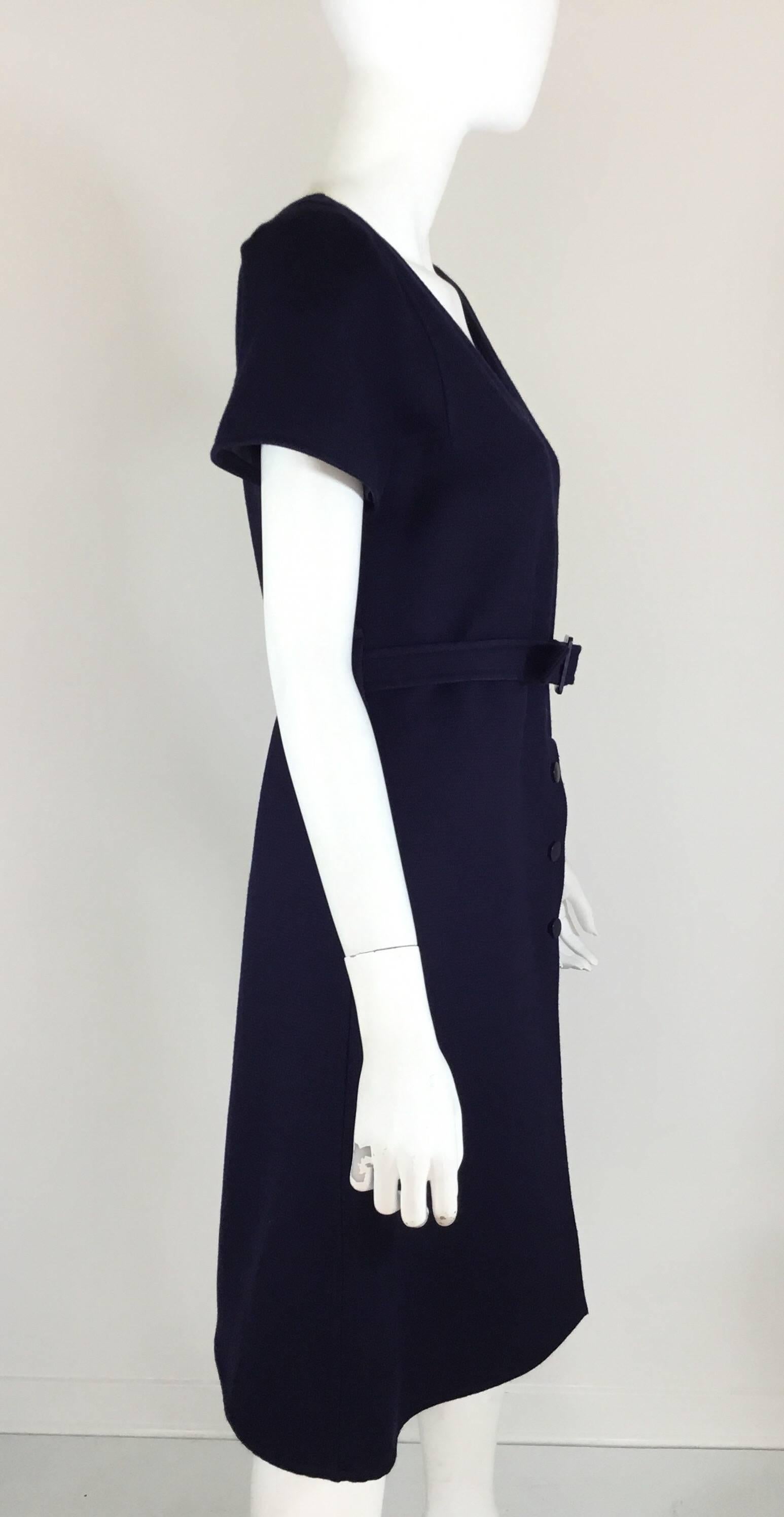 Courreges 1970s A-line structured wool dress in navy features a belted waist with a zipper and button front closure. Dress is fully lined, made in France and labeled Couture Future size A.

bust 35'', waist 30'', hips 40'', length 36''