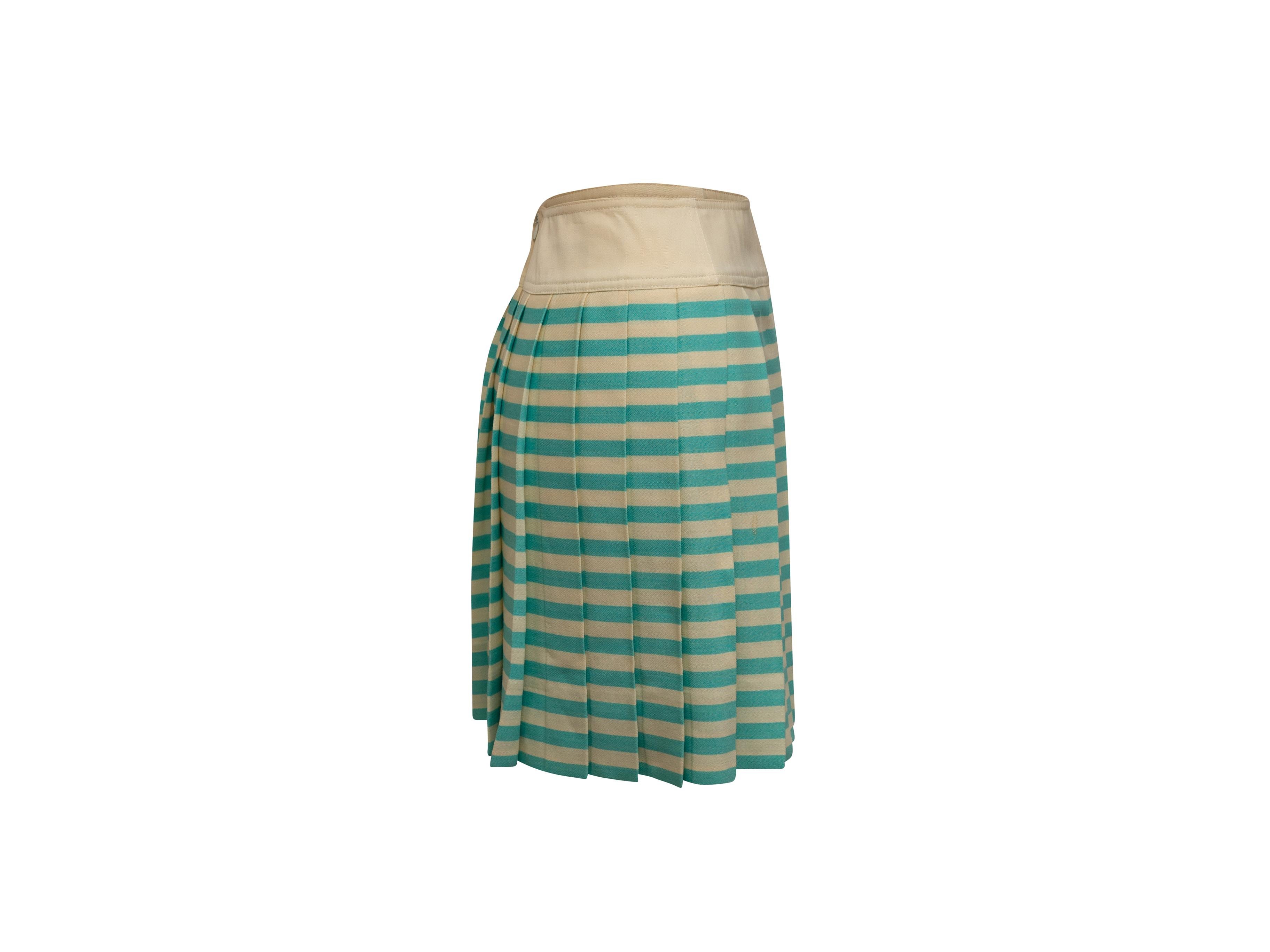 Product details: Vintage cream and turquoise wool pleated mini skirt by Courreges. Striped pattern throughout. Zip closure at back. Designer size 36. 28