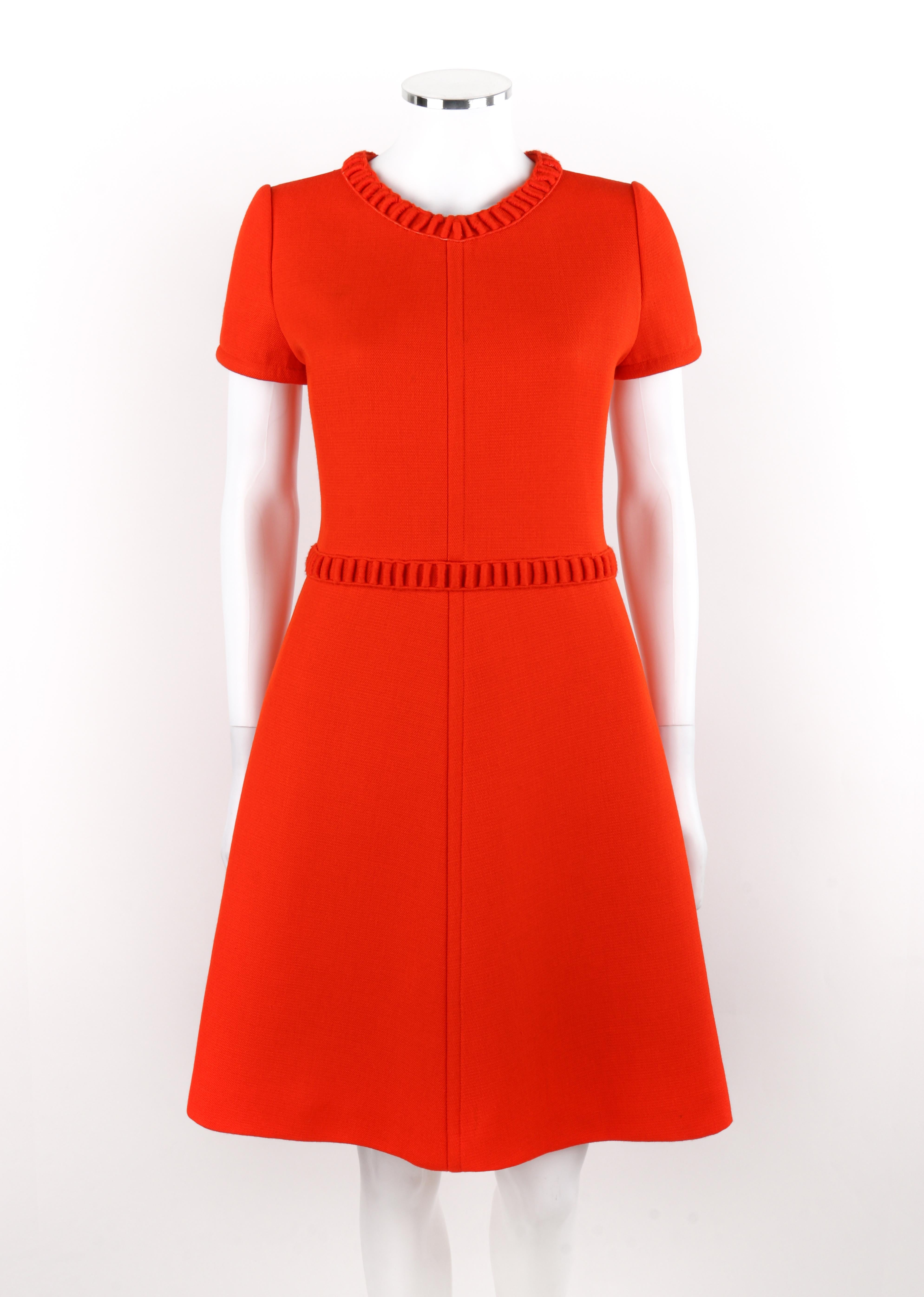 COURREGES Early c.1960's Orange Wool Embroidered Trim Short Sleeve A-Line Dress

Brand / Manufacturer: Courreges 
Circa: Early 1960s
Designer: Andre Courreges
Style: A-Line Dress
Color(s): Shades of orange, white
Lined: Yes
Unmarked Fabric Content