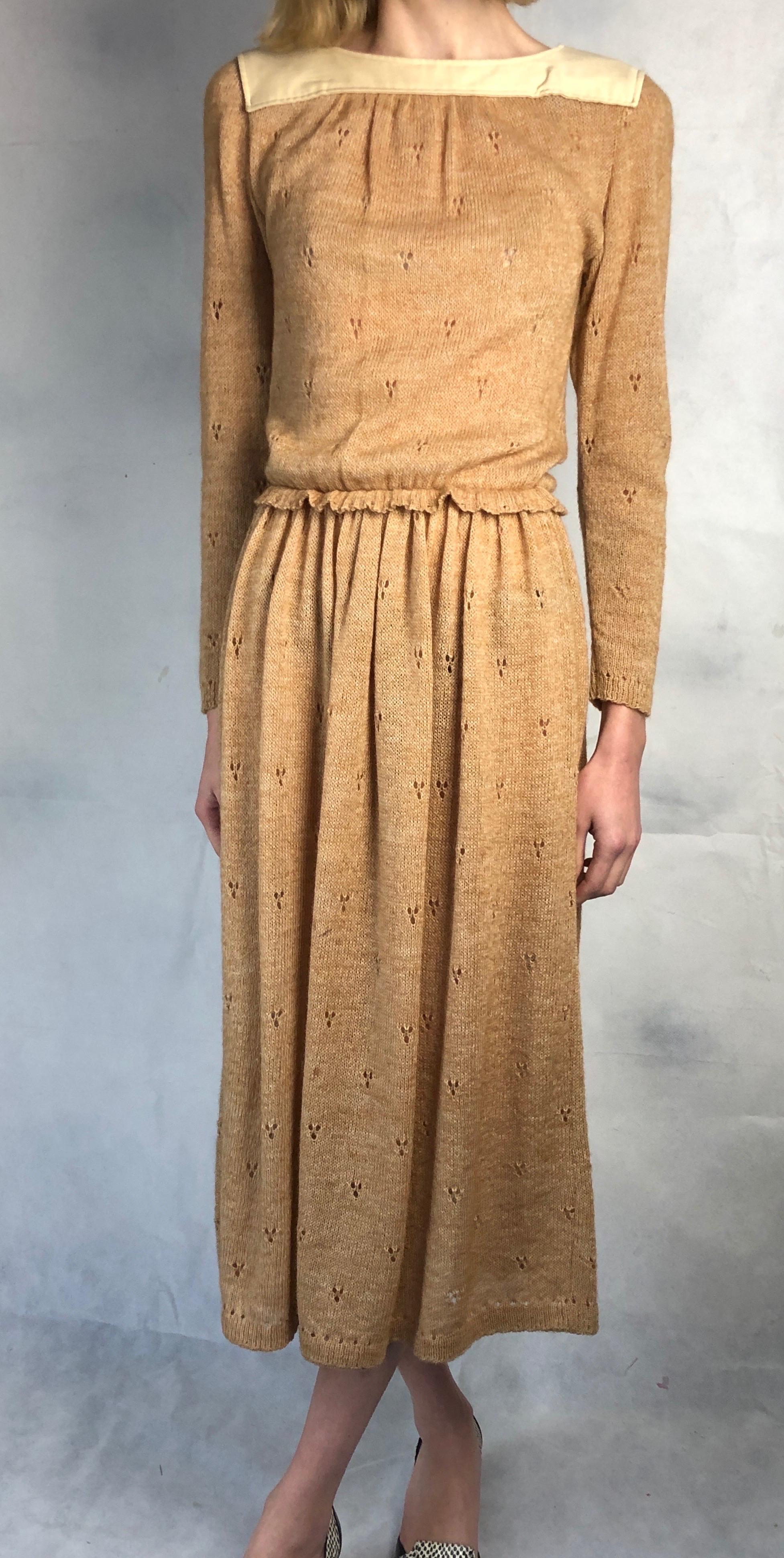 This Courreges mohair piece is made from Pointelle stitches. This fine knit pattern make the fabric lightweight , delicate and suitable for warm climates also. The dress is decorated with a square upper collar plaston made of cotton. its features