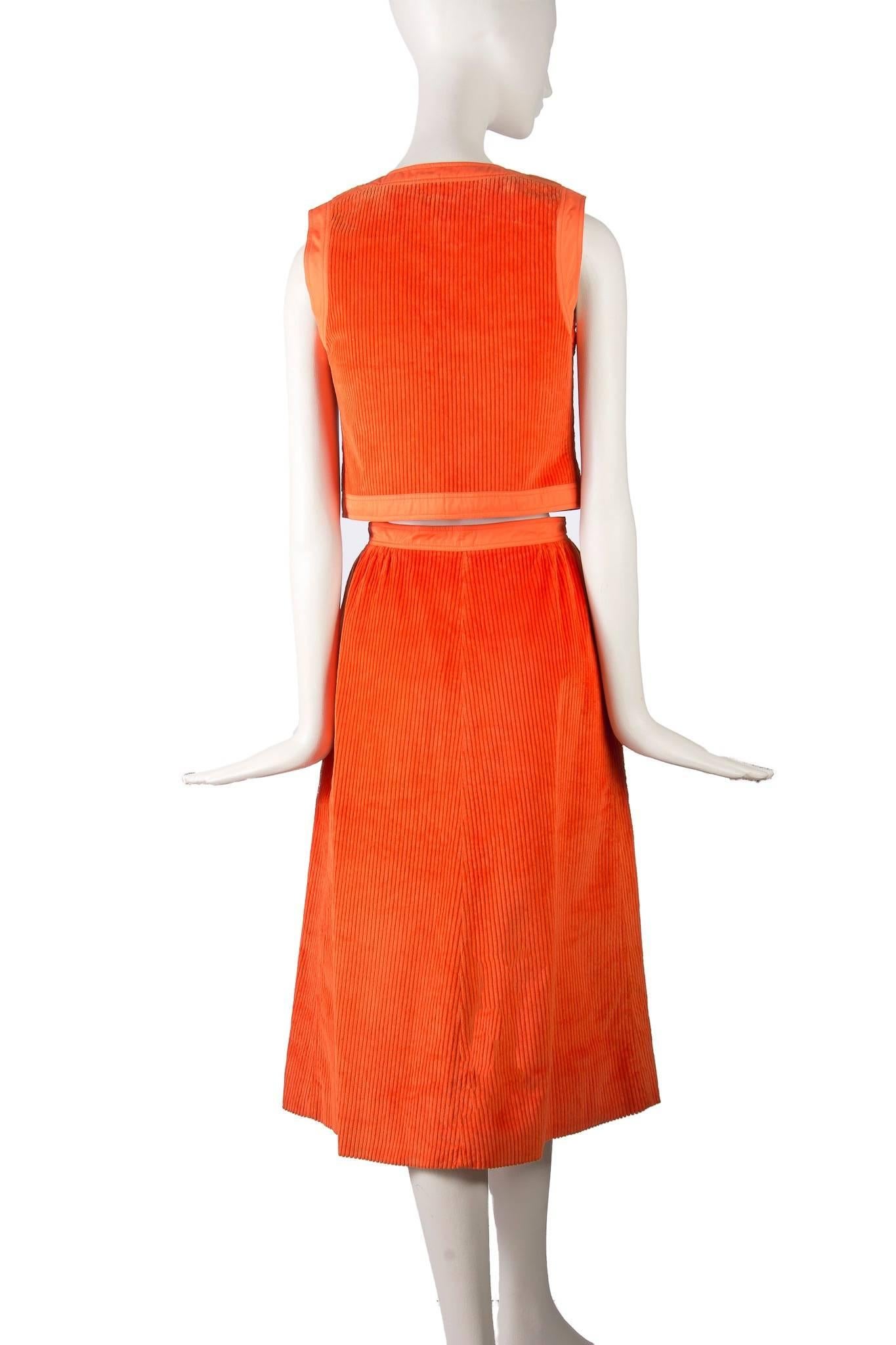 Presented here you have a fabulous 1970's Correges mint condition wide wale orange corduroy skirt with matching vest. The beautiful vest has four buttons closure down the front of the vest. The entire vest is surrounded by 1.5 inches of cotton,