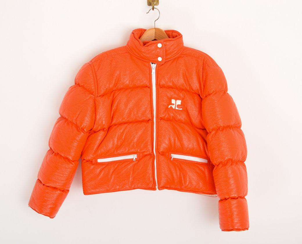 An Iconic, futuristic orange coloured vinyl puffer jacket by Courrèges.
Circa 2000.

Features;
 
Central line Contrasting White Zip fasten
Hip pockets
Iconic Courrèges Space age logo
Fully lined
85% Cotton / 15% Polytheurane 

Sizing;
Jacket; 
Pit