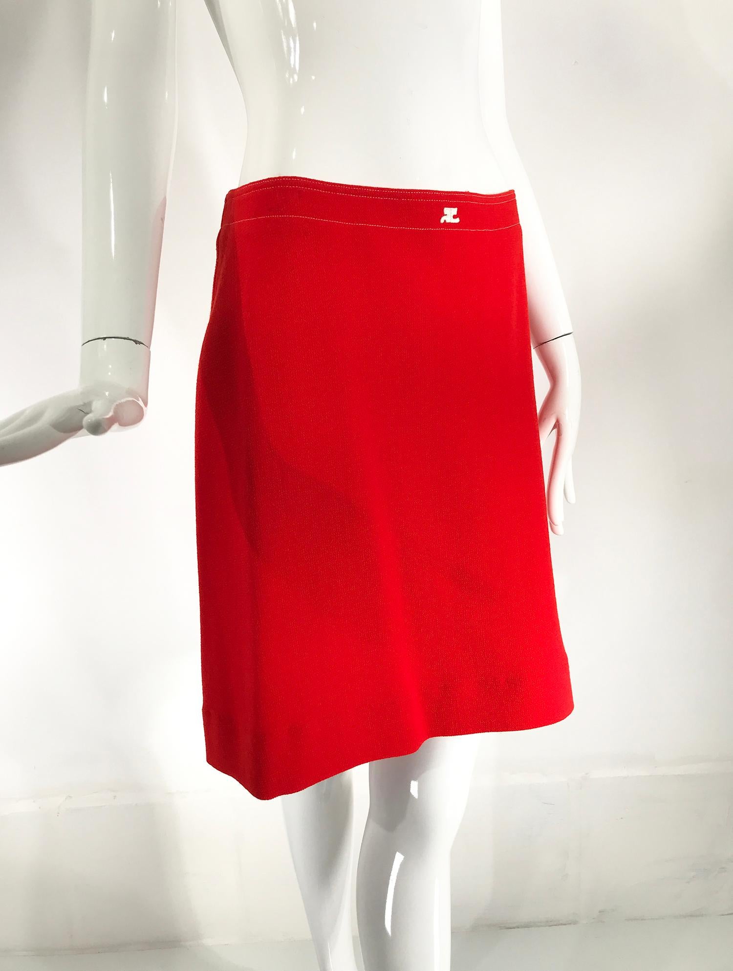 Courreges orange wool A line skirt with white top stitching marked size 42 from the 1990s. Contoured, top stitched waist band waist with logo applique at the front. Back sides top stitched seams, the left set with an invisible zipper. Lined in white