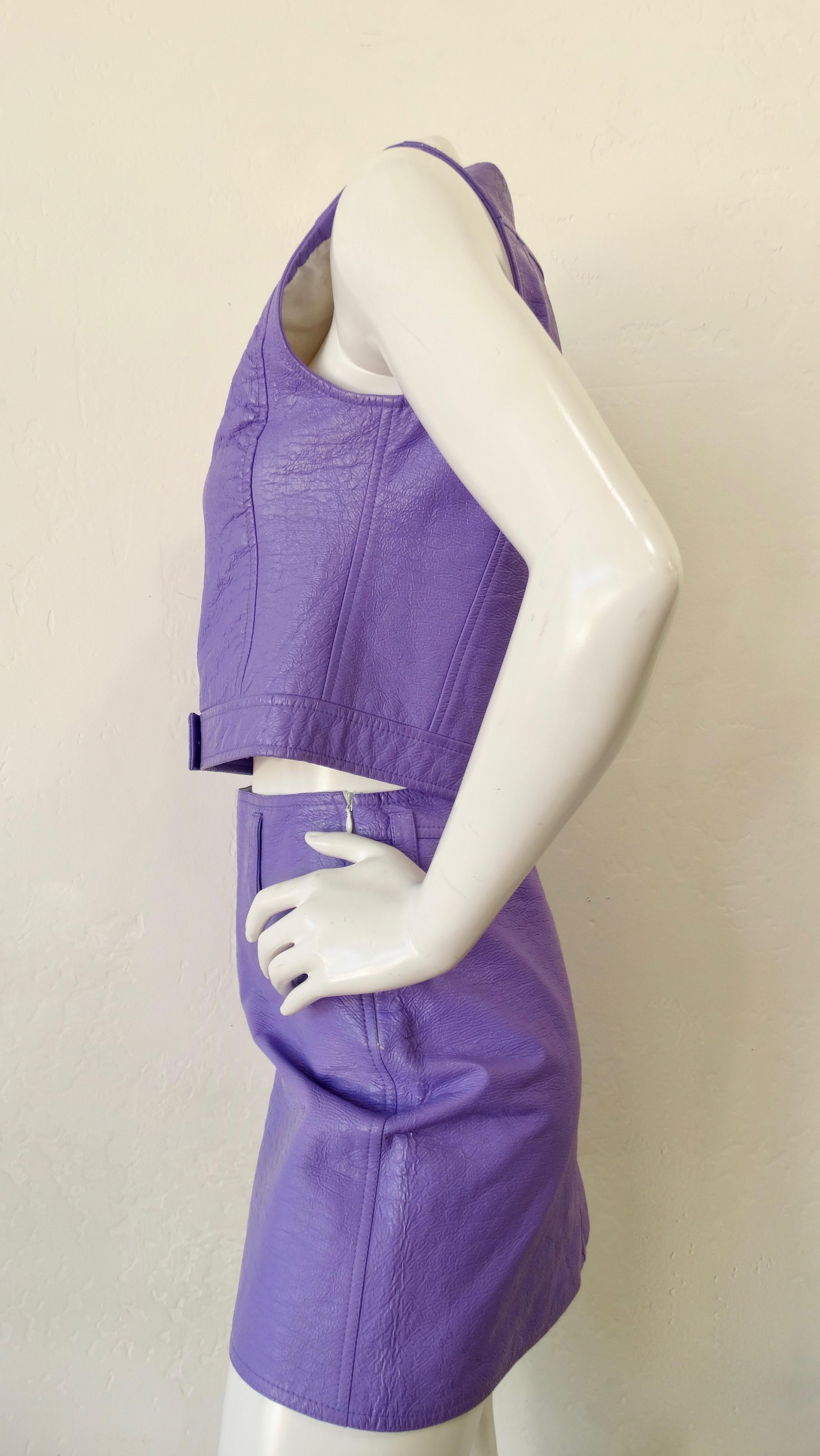 Snag yourself a piece from Courréges' space age era with this outfit! Circa late 1960s/ early 1970s, this outfit features a purple skirt and vest with a textured finish. Vest includes a notched collar, white snap buttons and the Courréges logo.