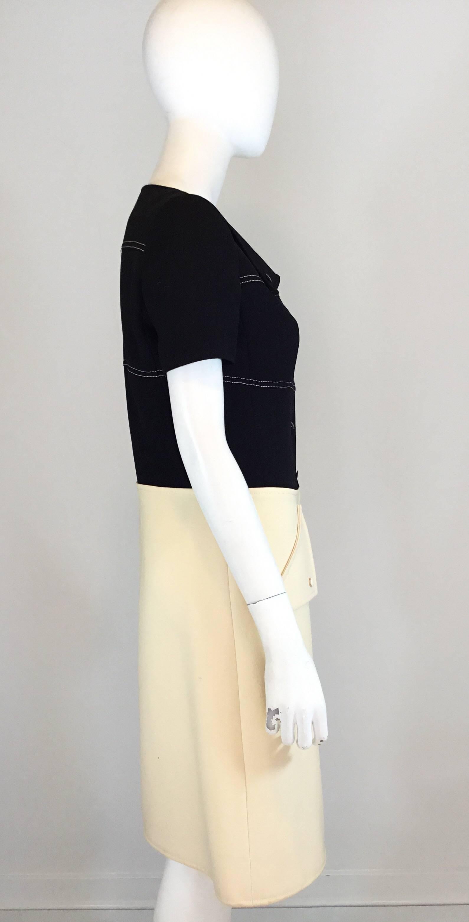 Courreges vintage 1960's color block structured wool dress features button closures along the front, faux pockets at the waist and fully lined. Made in France. Excellent condition.

Measurements:
bust 34'', waist 32'', hips 38'', length 40'',