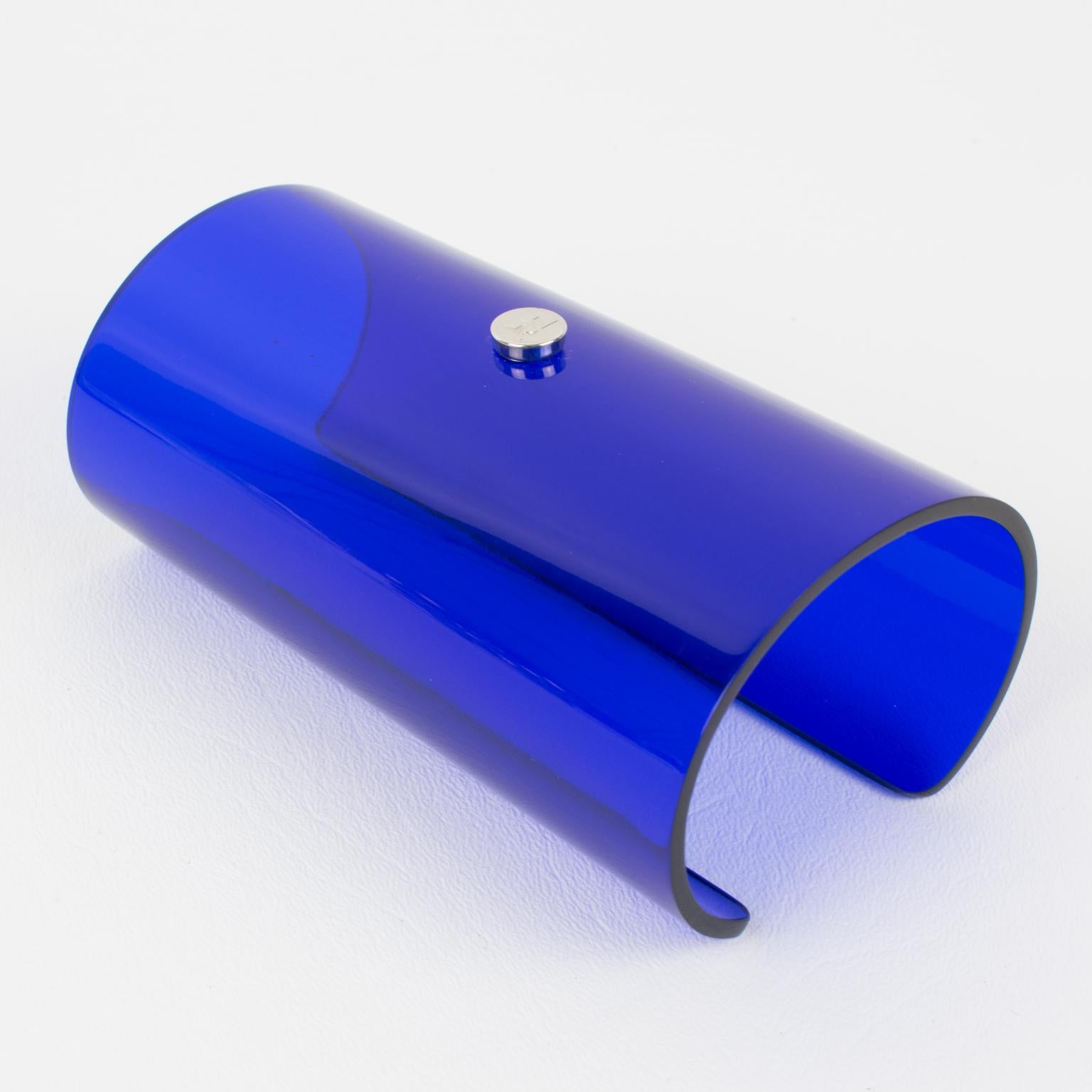 This stunning Courreges Paris massive bangle bracelet features an oversized cuff design in transparent cobalt blue resin or Lucite. The piece has a spectacular cone shape and is signed on the front with chrome metal AC Courrege's iconic brand
