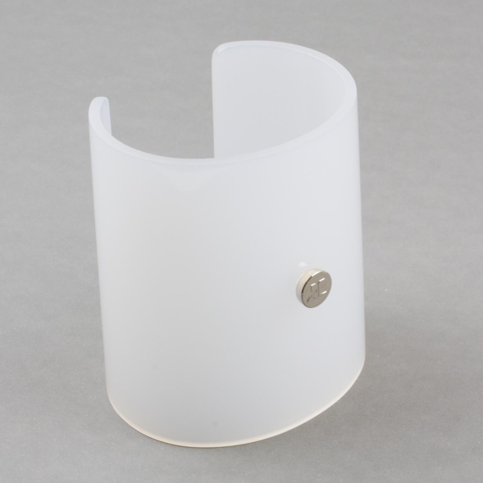 Courreges Paris designed this handsome cuff bracelet. The oversized cuff design is made of white opalescent resin or Lucite. The piece has a spectacular cone shape and is signed on the front with a chrome metal 