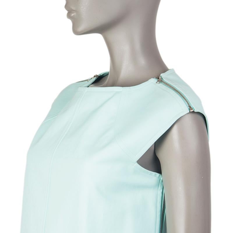 100% authentic Courreges cap-sleeve shift dress in light turquoise cotton (95%) and elastane (5%). With rippers on the shoulders. Closes with two-way pewter zippers on the sides. Lined in white fabric. Has been worn and is in excellent condition.