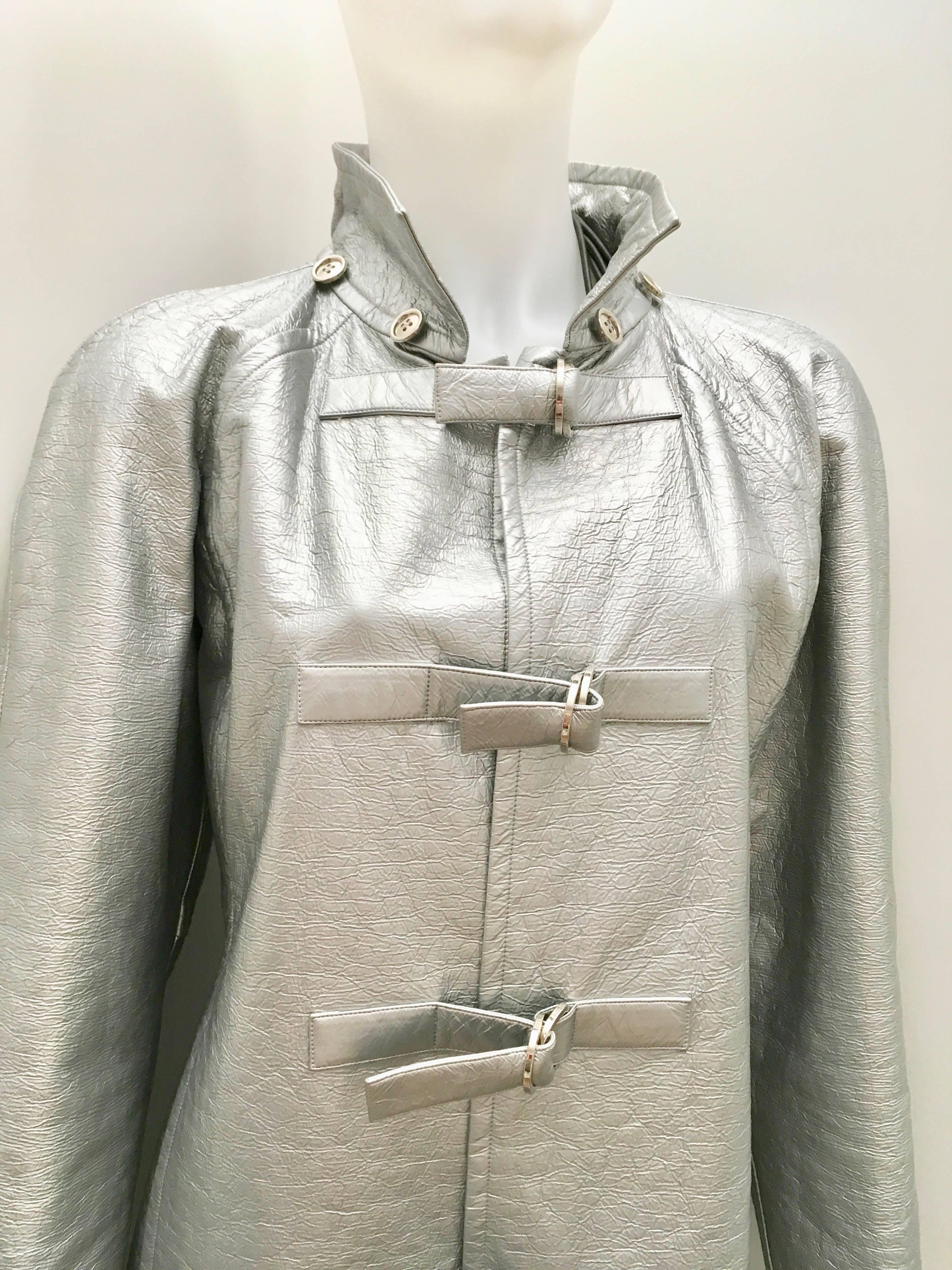 Presented here is an extremely rare style of a Courreges Patent Silver Coat.
Truly Magnificent. I have not seen this style before.  I am not sure if it is from the 1980's but from the label this is my best guess.  A true masterpiece and extremely