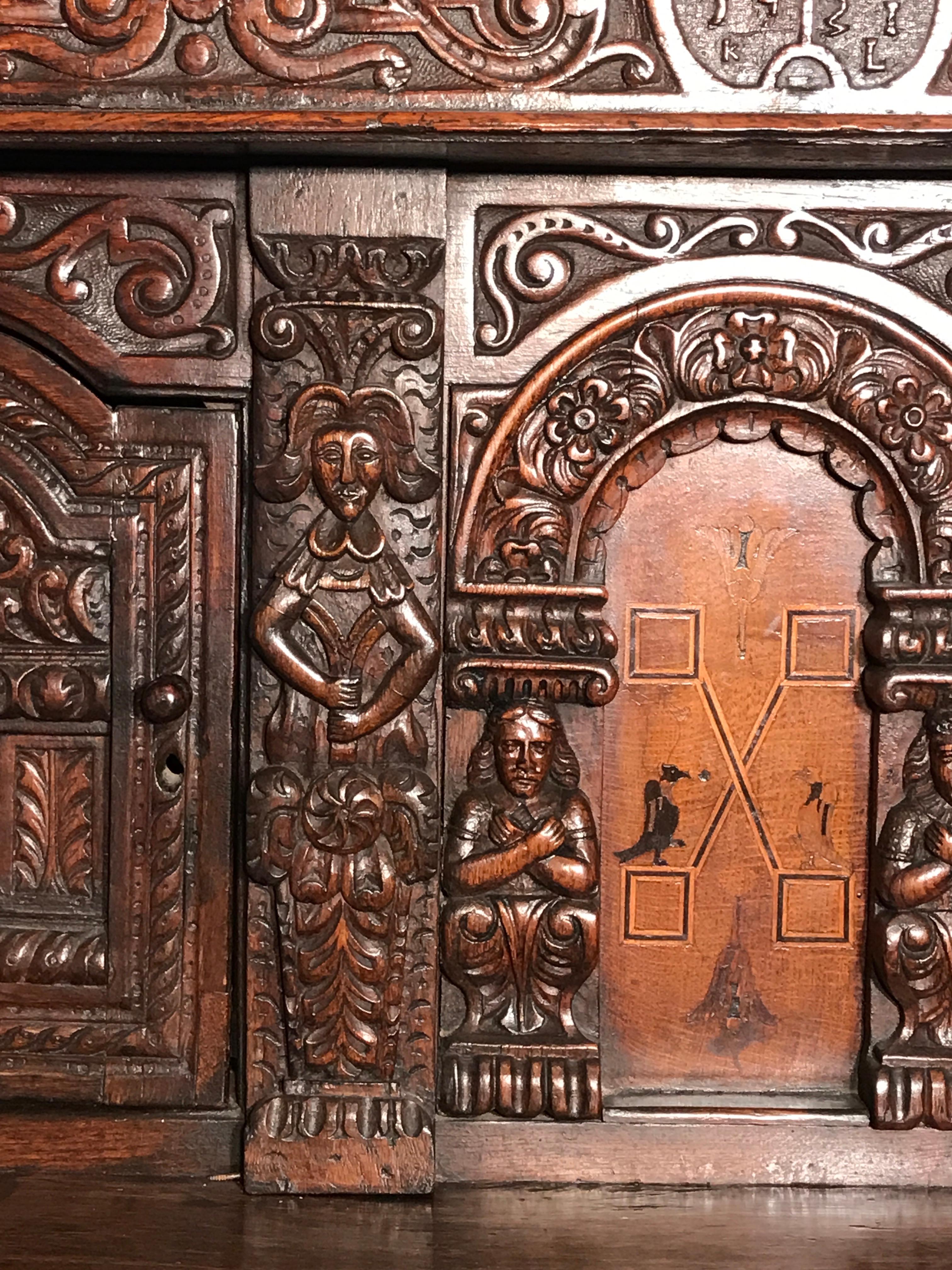 Court Cupboard Dated 1731 Initialled RR KL Inlaid Oak Fruitwood Masks In Good Condition For Sale In BUNGAY, SUFFOLK