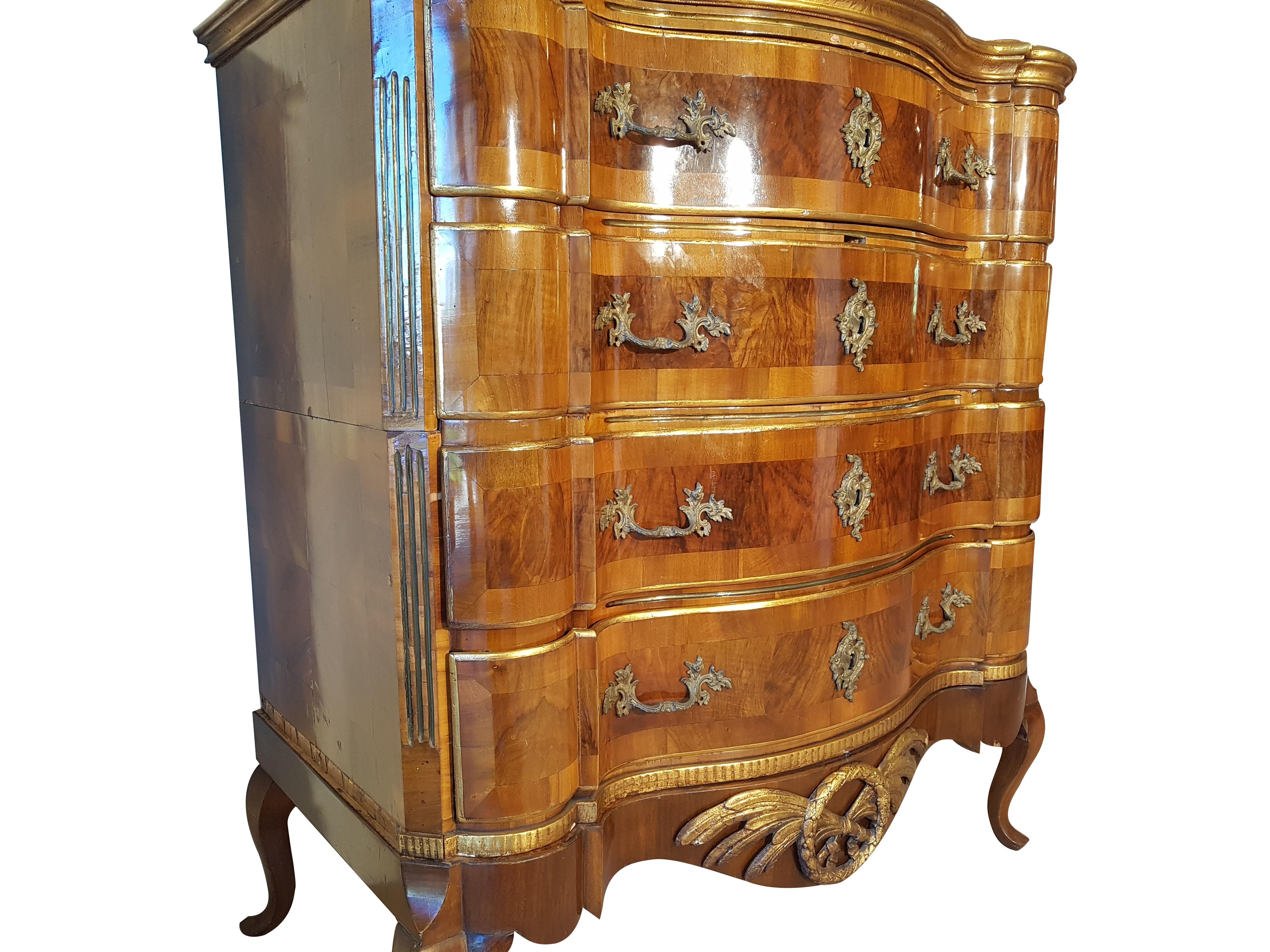 This beautiful and rare courtly commode from the Rococo period - handles and key cartridges made of bronze - is carefully and thoroughly restored - preserving the patina - and polished by hand with shellac. Four big drawers make up a great storage