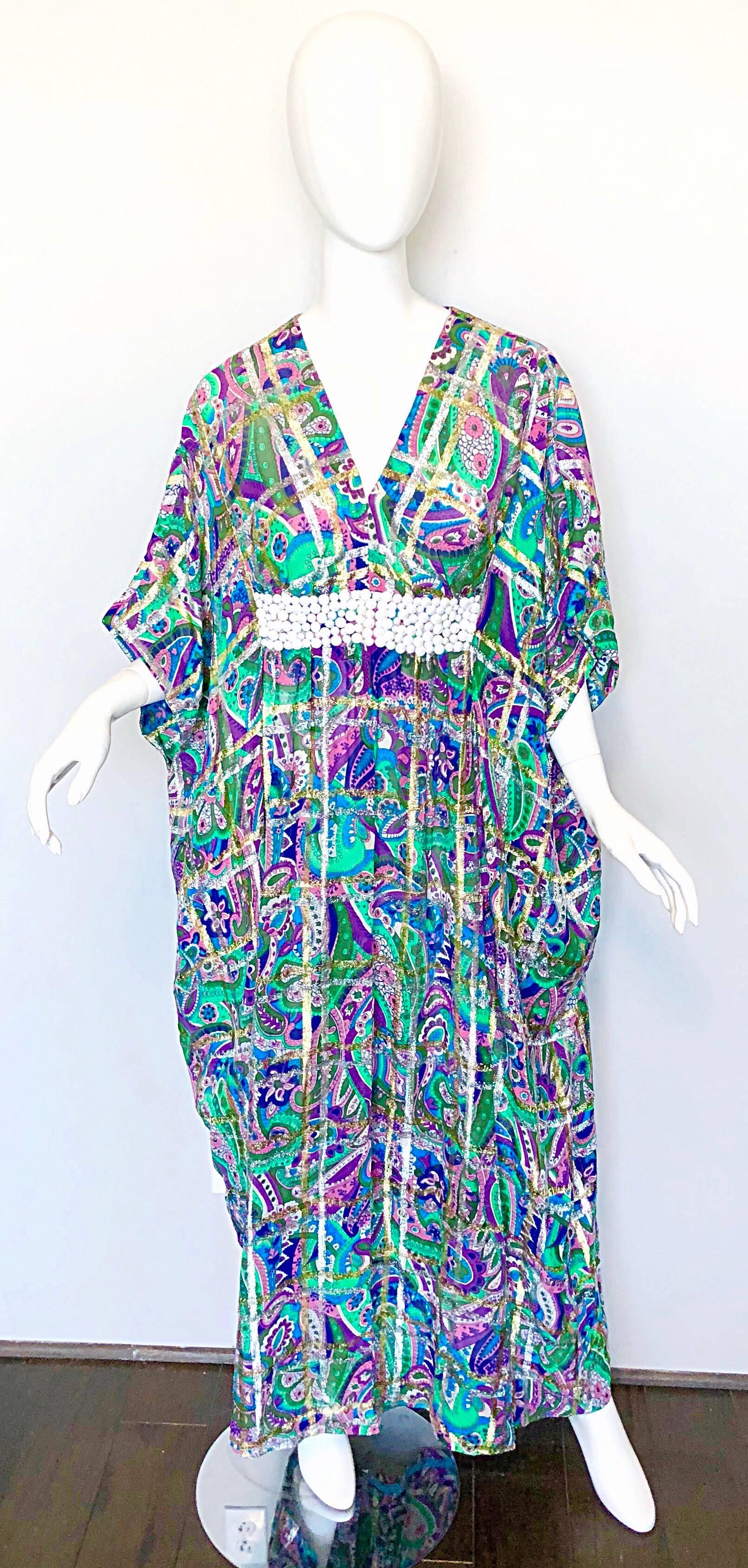 AMAZING 70s silk chiffon beaded kaftan / maxi dress! Features a wonderful paisley mixed media print. Vibrant colors of purple, blue, green, pink, fuchsia, turquoise, teal, and white. Stripes in metallic gold and silver throughout. Hand-sewn white