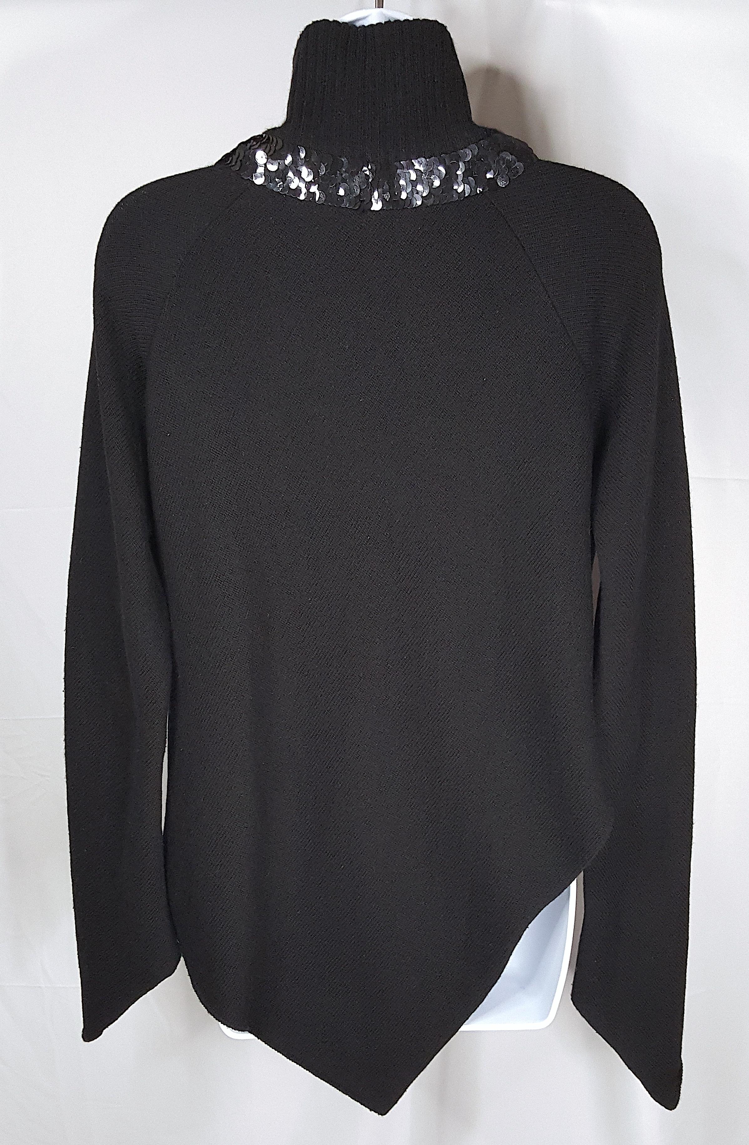 Uniquely designed as couture by French Jean Charles de Castelbajac in the 1980s, this oversized soft cashmere-viscose-wool bias-cut Italian-knit black sweater with made-in-France tuxedo-like hand-sewn sequin trim is a pullover with V-shaped rolled
