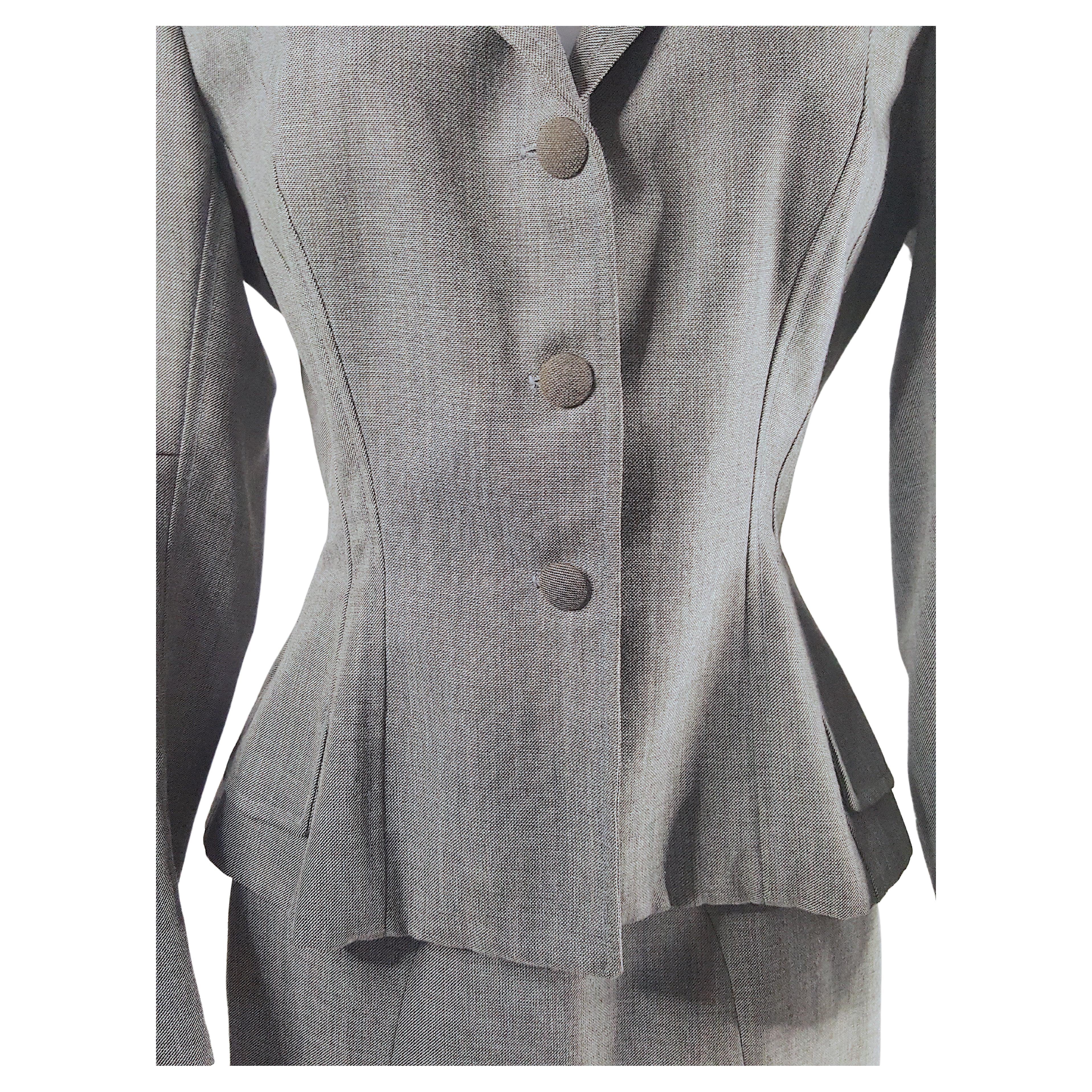 As French couture made by Martin Grant at his Paris atelier in the Marais in the mid-1990s, this pale grey plaid lightweight-wool slit-skirt suit has many hand-tailored elements like a Christian-Dior original from 1947 that create a curvaceous