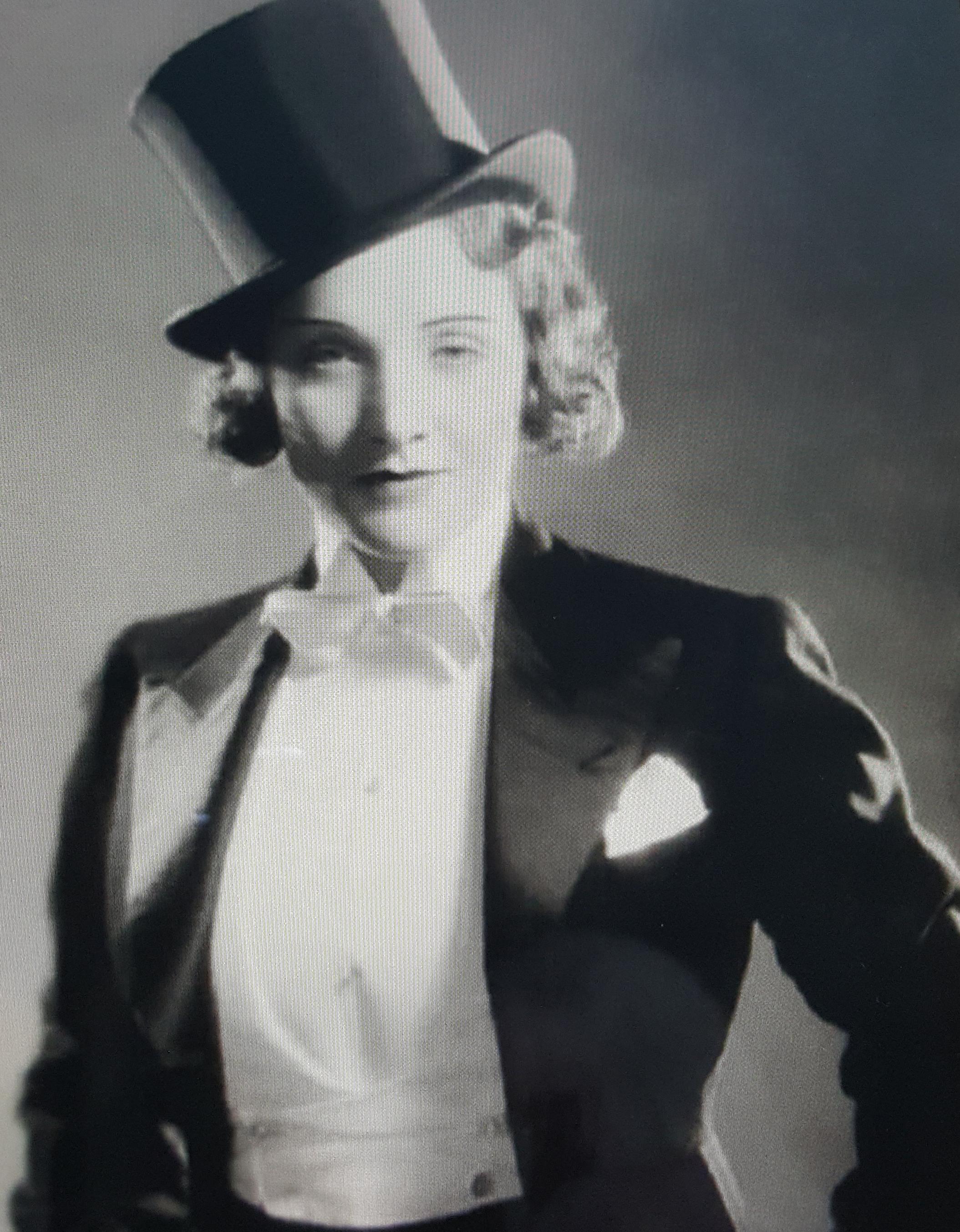 This antique ArtDeco-period couture British wool-and-satin black tuxedo button-decorated open-breasted tailcoat fits a women's U.S.-size 6 so well that we think it was custom-made for one. A hidden printed label identifies the craftsman as Harry Kay