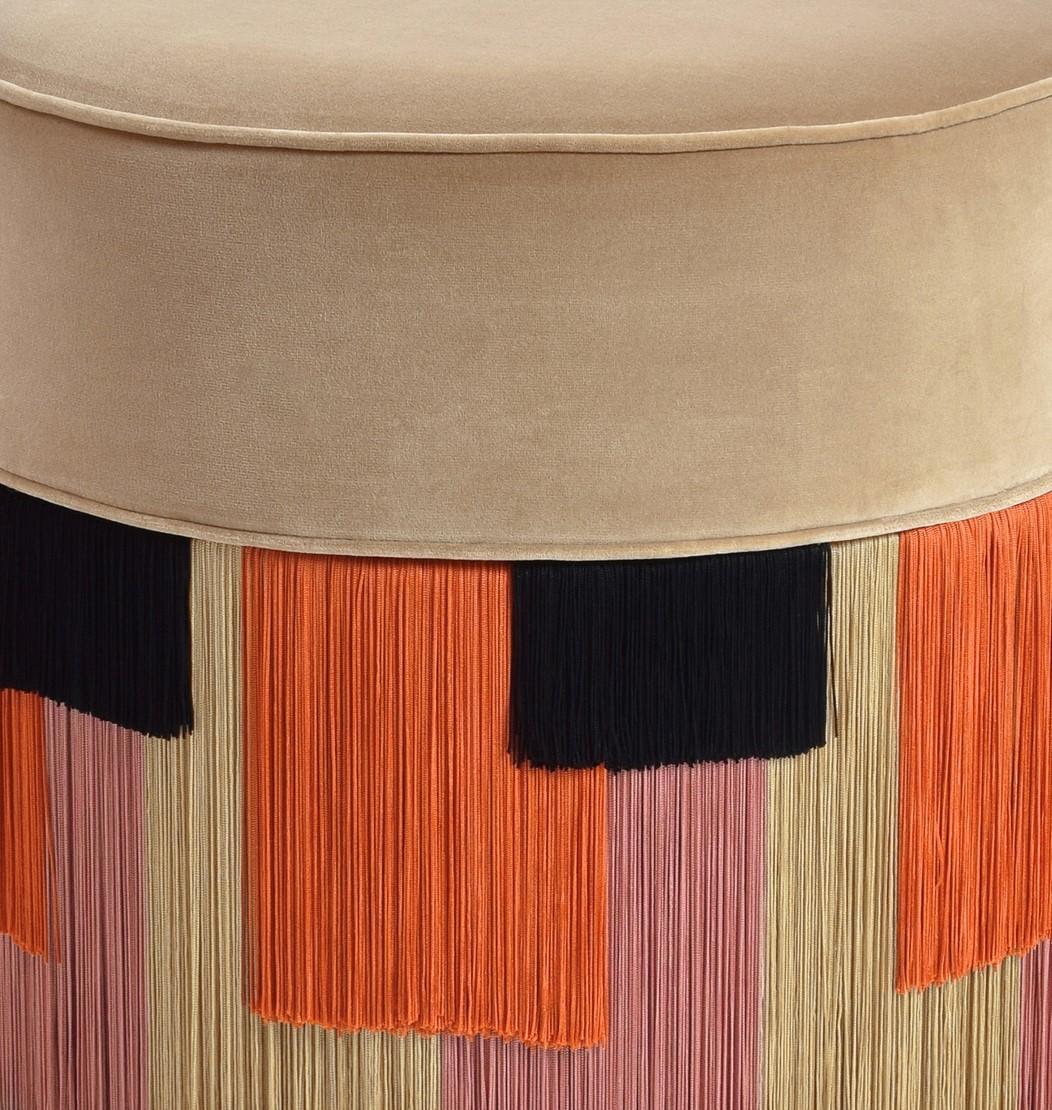 Boasting sartorial appeal and exotic flair, this couture pouf will be a sophisticated accent in a minimalist or contemporary patio or bedroom decor. The round beech wood frame with four black-finished legs supports the bold seat cushion upholstered