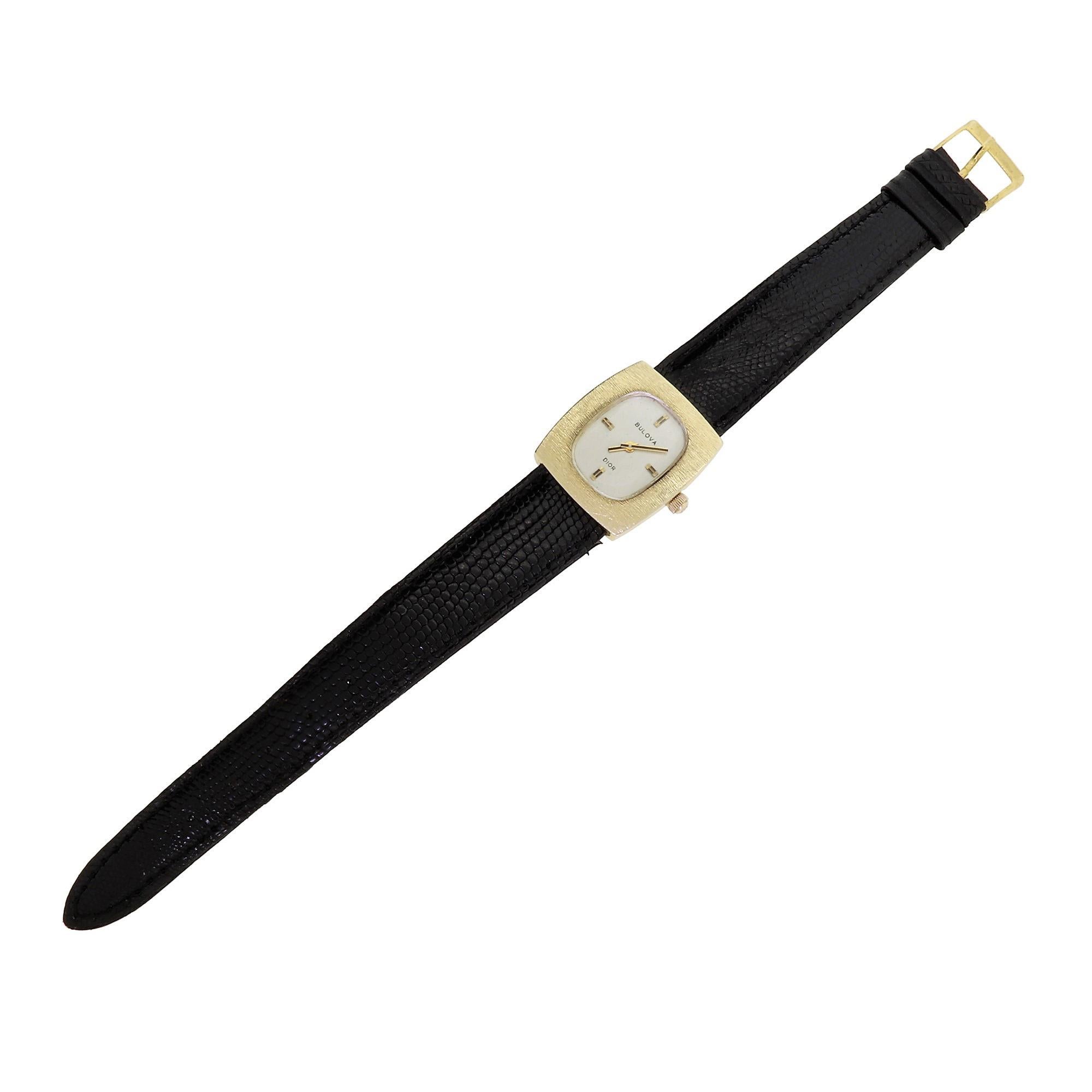 Vintage late 1960s couture ladies watch by Bulova for Christian Dior. Features a solid 14K yellow gold case and crown complemented by a minimalist white dial with gold hand and index accents. This timeless and elegant design by Dior has become