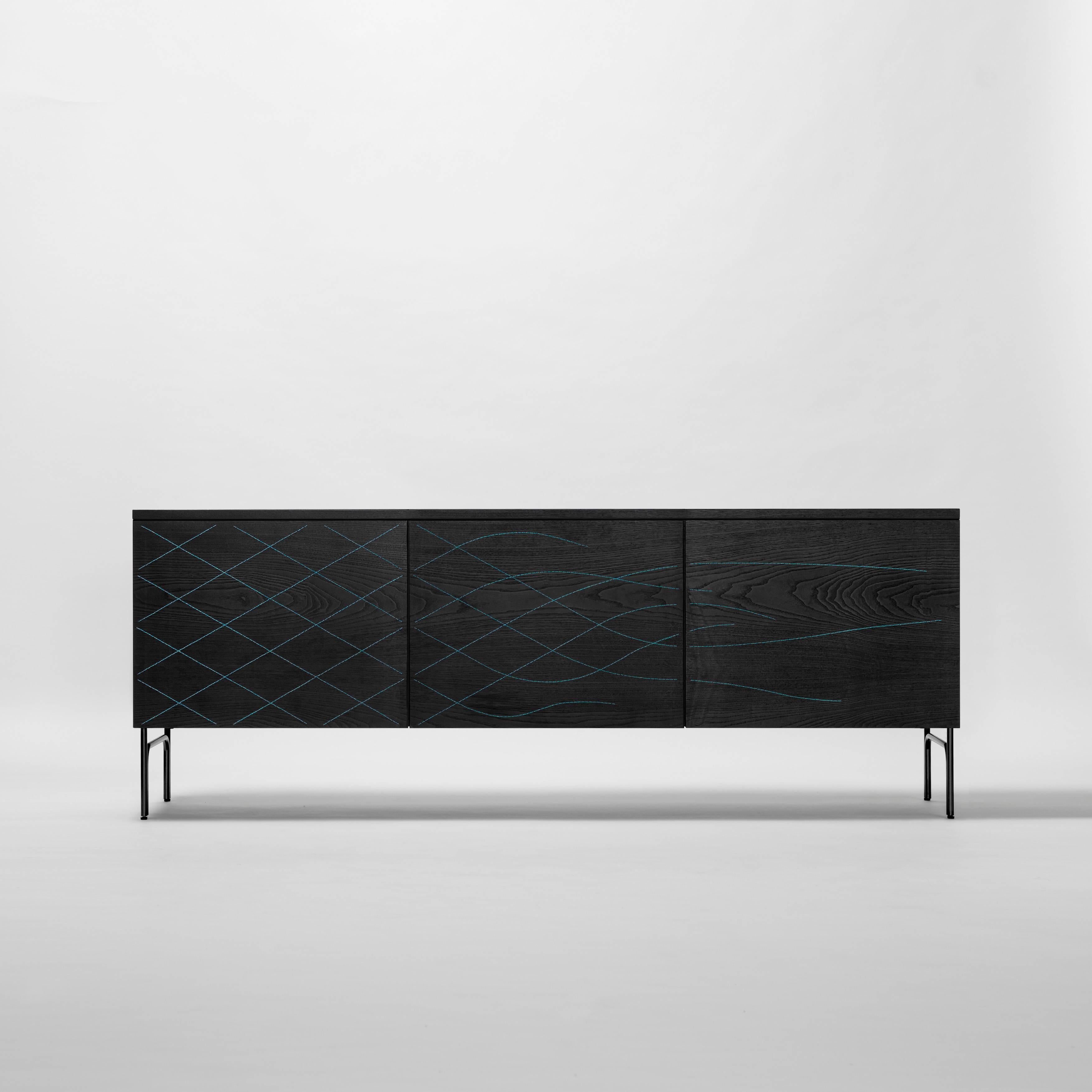 Cabinet designed by Färg & Blanche manufactured by BD Barcelona

Sideboard in stained black. Structure in anodic black lacquered steel. Doors sewn in black, blue or orange thread.

     